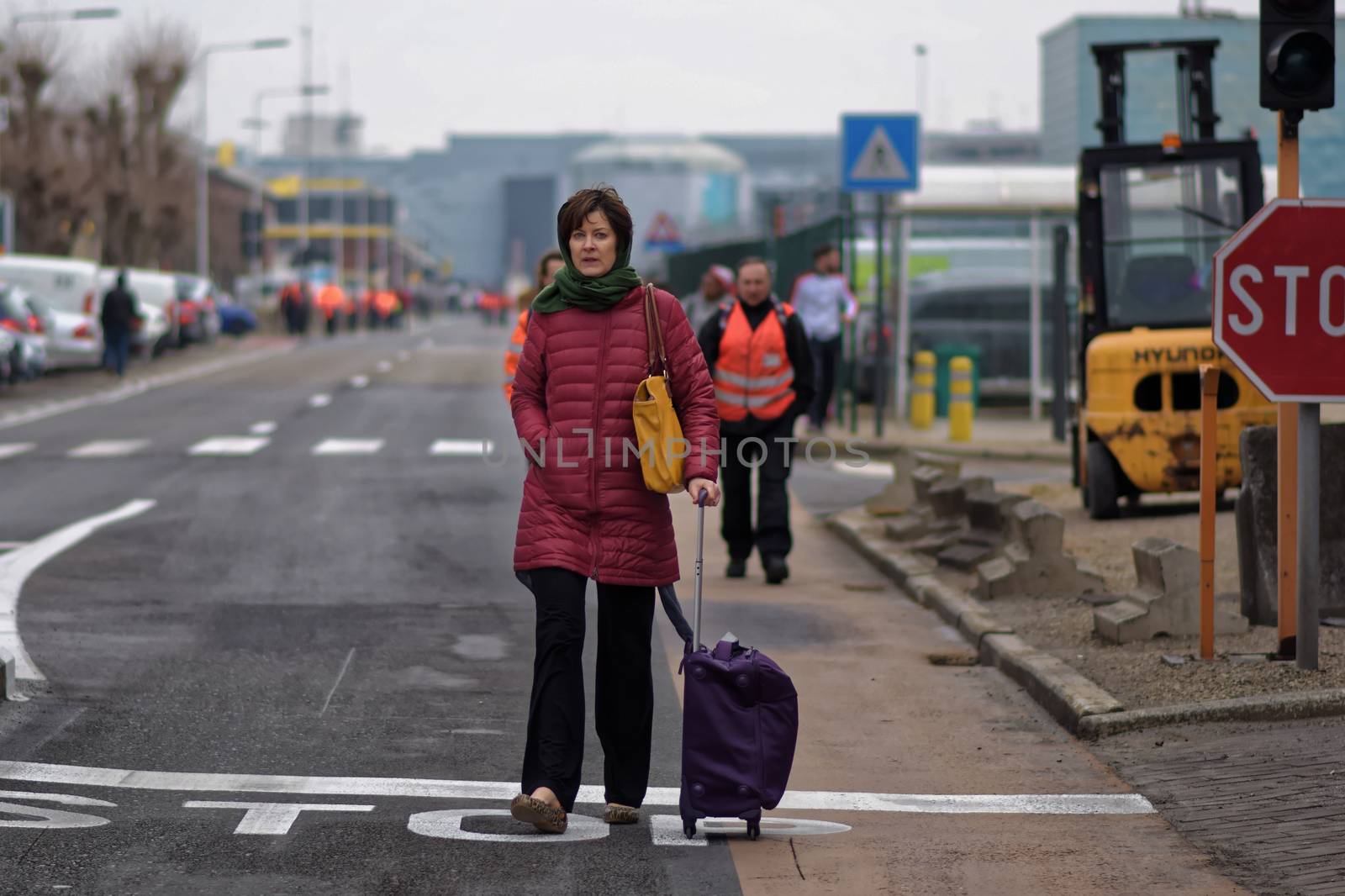 BELGIUM, Brussels: Passengers leave Brussels airport, on March 22, 2016 in Zaventem , following its evacuation after at least 13 people were killed and 35 injured as twin blasts rocked the main terminal of Brussels airport.