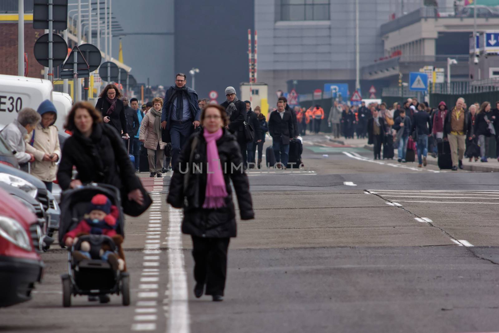 BELGIUM, Brussels: Passengers leave Brussels airport, on March 22, 2016 in Zaventem , following its evacuation after at least 13 people were killed and 35 injured as twin blasts rocked the main terminal of Brussels airport.