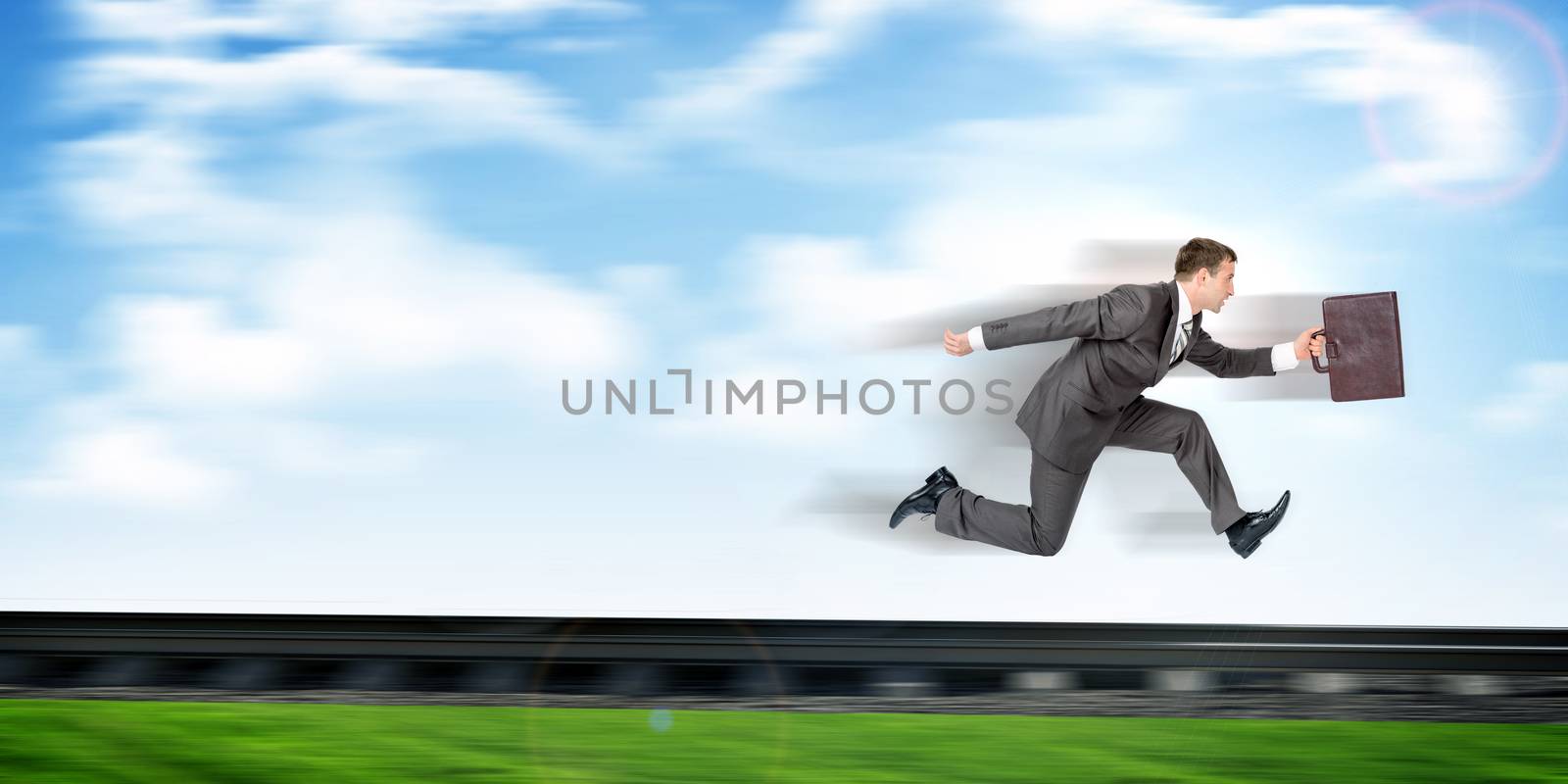Businessman with suitcase running away on rail-track