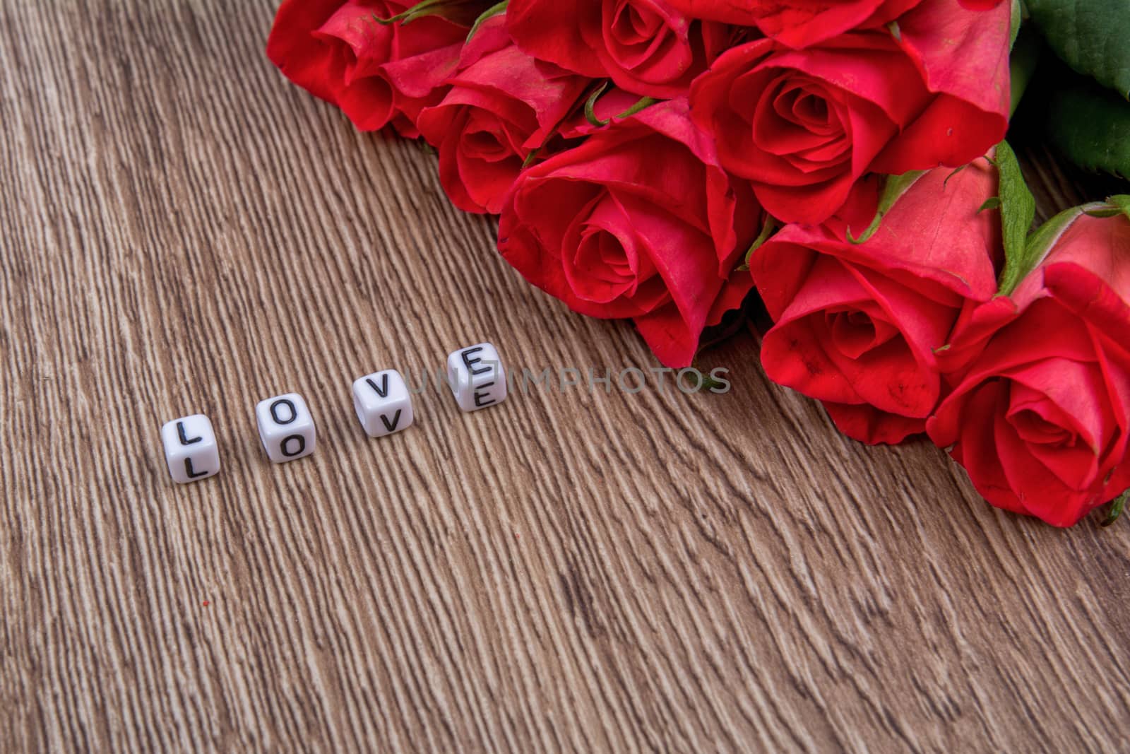 White cubes as a inscription love on a wooden background