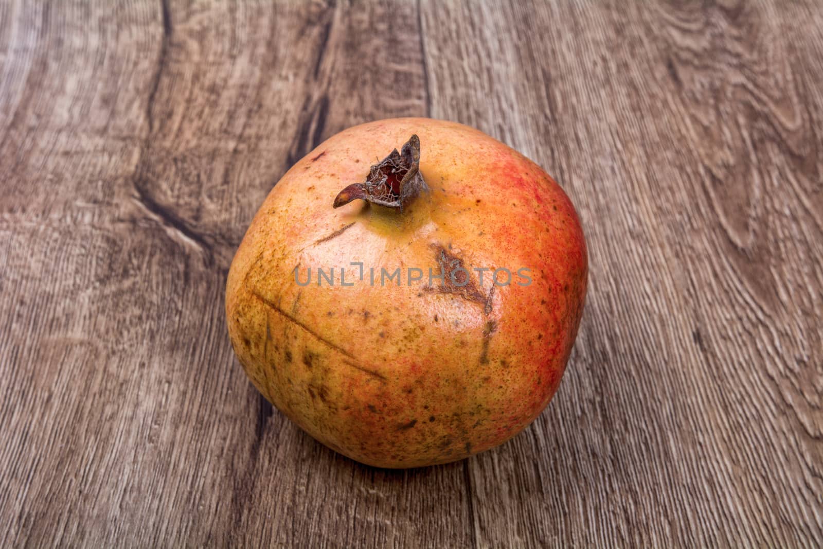 Pomegranate on a brown wooden background