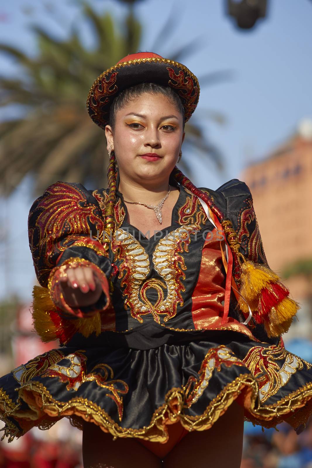 Caporales dancers in ornate costumes performing at the annual Carnaval Andino con la Fuerza del Sol in Arica, Chile.