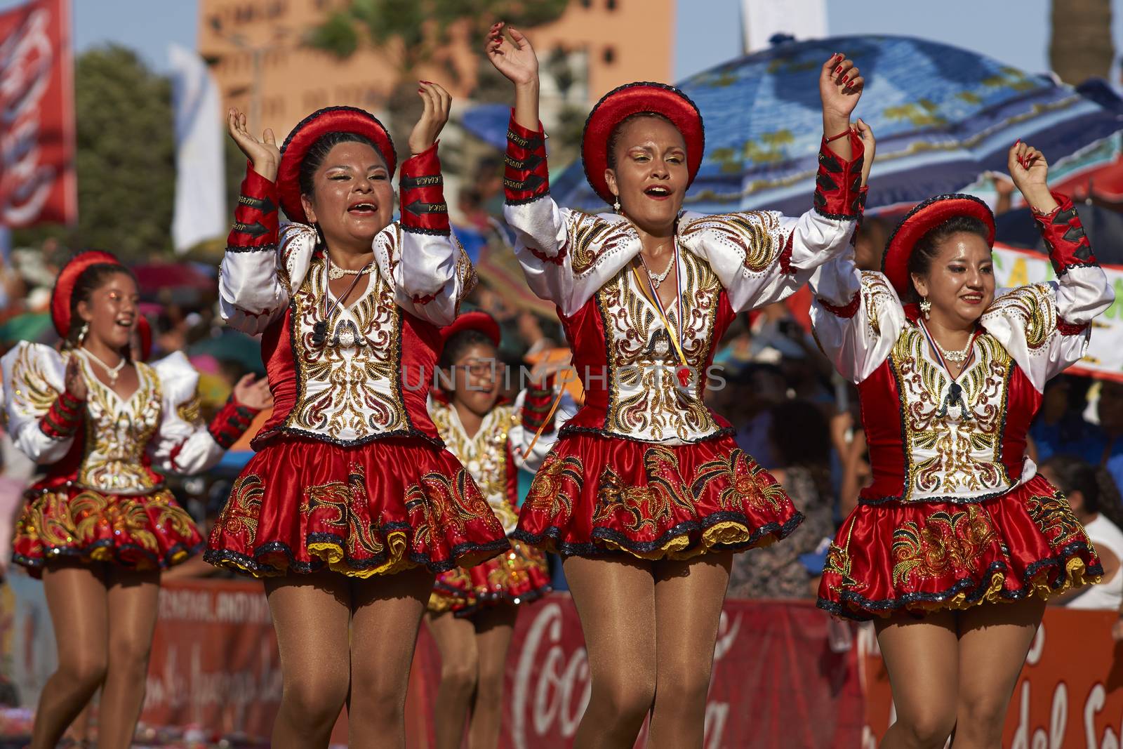 Caporales dancers in ornate costumes performing at the annual Carnaval Andino con la Fuerza del Sol in Arica, Chile.