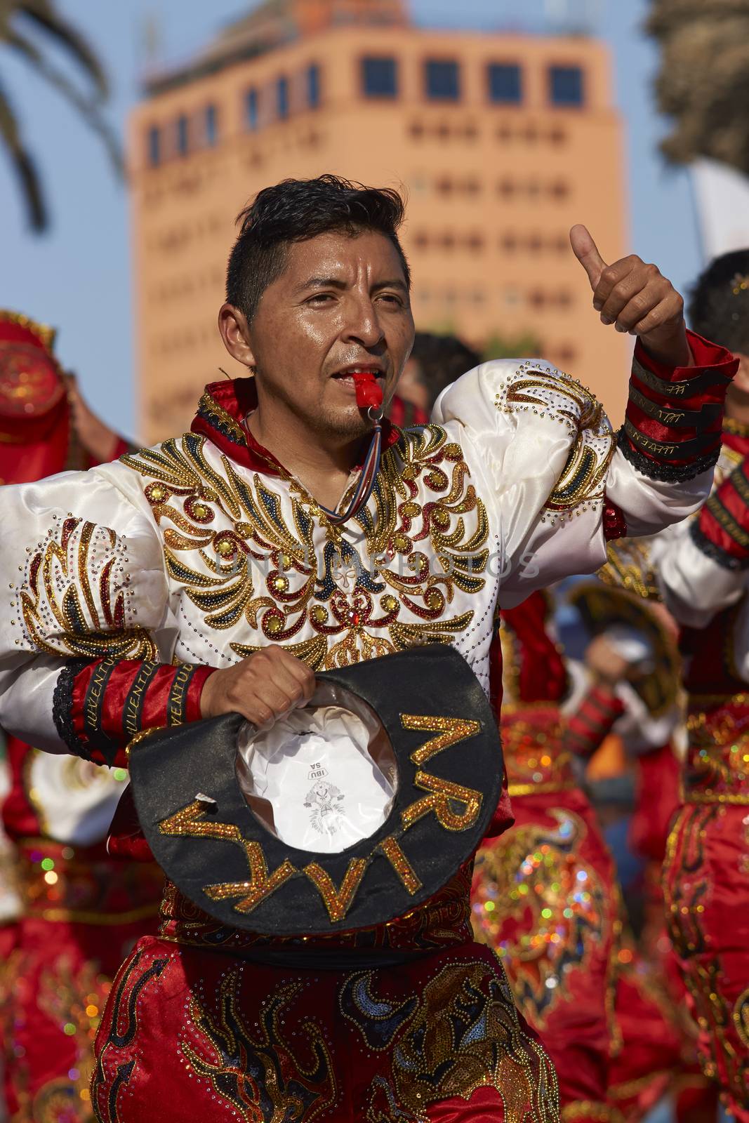 Male Caporales dancer in ornate costume performing at the annual Carnaval Andino con la Fuerza del Sol in Arica, Chile.