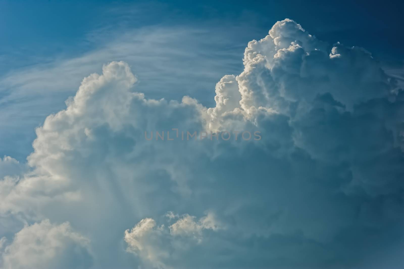 Large fluffy cloud relief details on blue sky