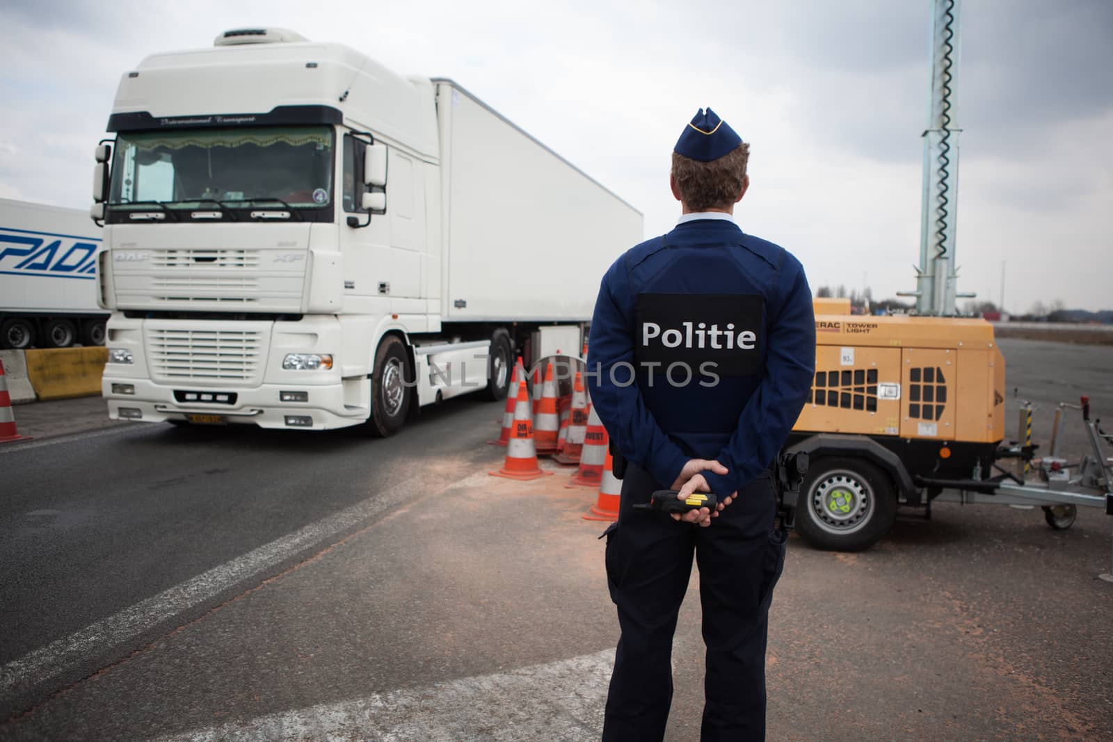 FRANCE, Neuville-en-Ferrain: Belgian police officer checks vehicles at the French-Belgian border, near Neuville-en-Ferrain, northern France, on March 22, 2016 , as security measures have been reinforced after a series of apparently coordinated explosions ripped through Brussels airport and a metro train on Tuesday, killing at least 26 people in the latest attacks to target Europe.