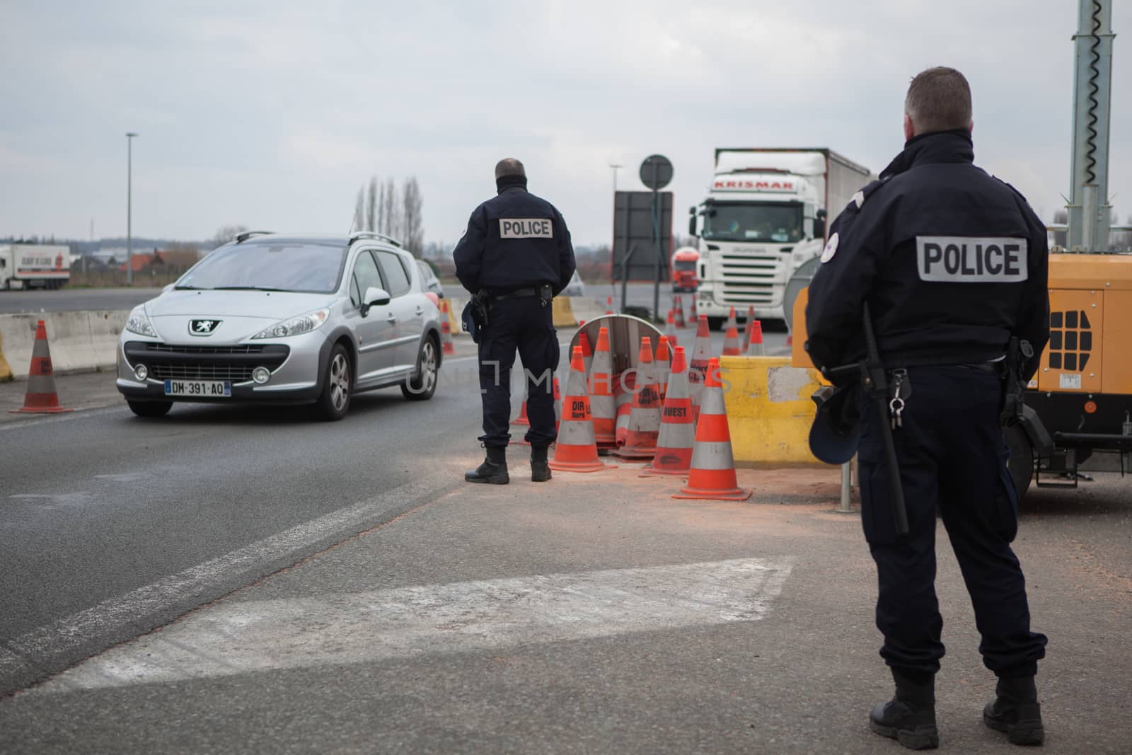 FRANCE, Neuville-en-Ferrain: French police officers check vehicles at the French-Belgian border, near Neuville-en-Ferrain, northern France, on March 22, 2016 , as security measures have been reinforced after a series of apparently coordinated explosions ripped through Brussels airport and a metro train on Tuesday, killing at least 26 people in the latest attacks to target Europe.