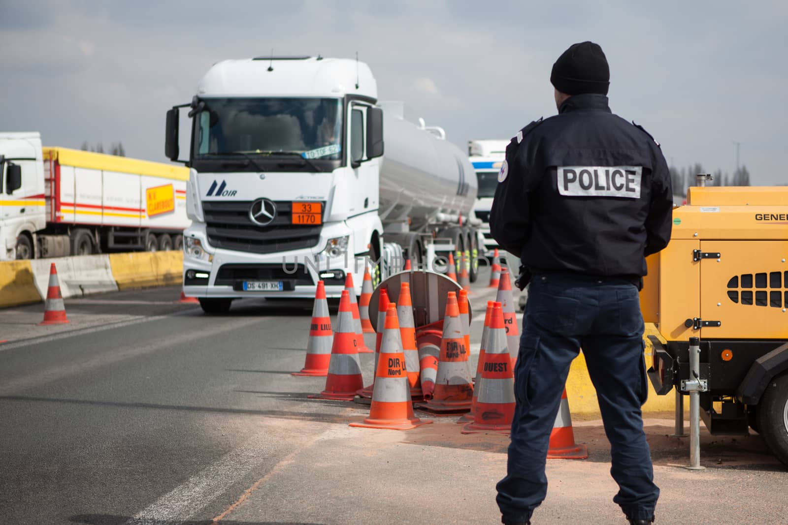 FRANCE, Neuville-en-Ferrain: A French police officer checks vehicles at the French-Belgian border, near Neuville-en-Ferrain, northern France, on March 22, 2016 , as security measures have been reinforced after a series of apparently coordinated explosions ripped through Brussels airport and a metro train on Tuesday, killing at least 26 people in the latest attacks to target Europe.