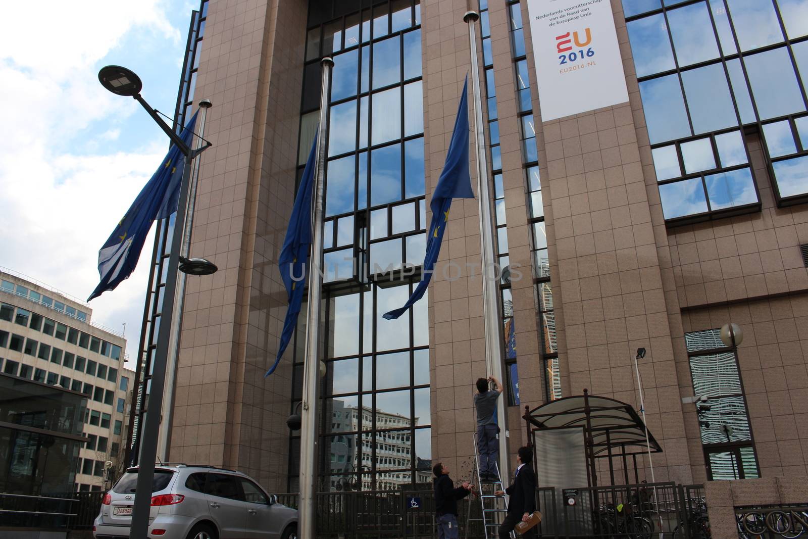 BELGIUM, Brussels: Flags outside the Council of the European Union in Brussels, Belgium are lowered following the deadly attacks at Maelbeek metro station and Zaventem airport on March 22, 2016. The attacks, at least one of which was carried out by a suicide bomber, left at least 30 dead, and scores more injured.