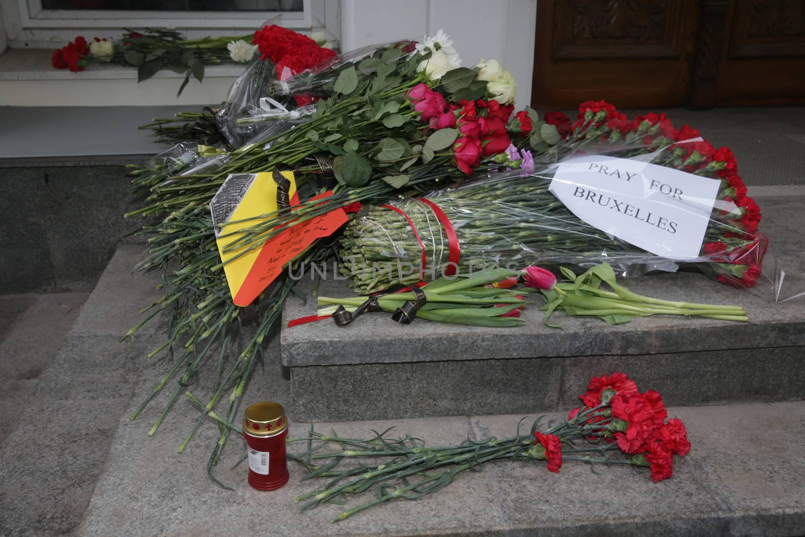 RUSSIA, Moscow: A makeshift memorial has taken shape at the Belgian Embassy in Moscow, Russia following the terror attacks that left at least 30 dead and hundreds injured in Brussels, Belgium on March 22, 2016. The Islamic State terror group has taken responsibility for the attacks, which brought death and destruction on Zaventem airport and Maelbeek metro station.