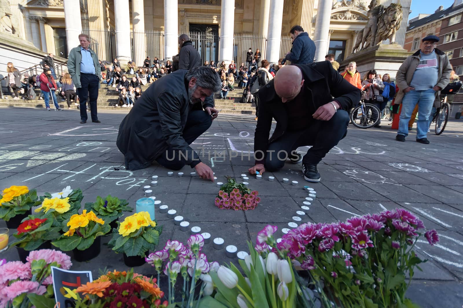 BELGIUM, Brussels: A man lights a candle in Brussels on March 22, 2016 in tribute to the victims of the attacks that hit the Belgian capital that same day.