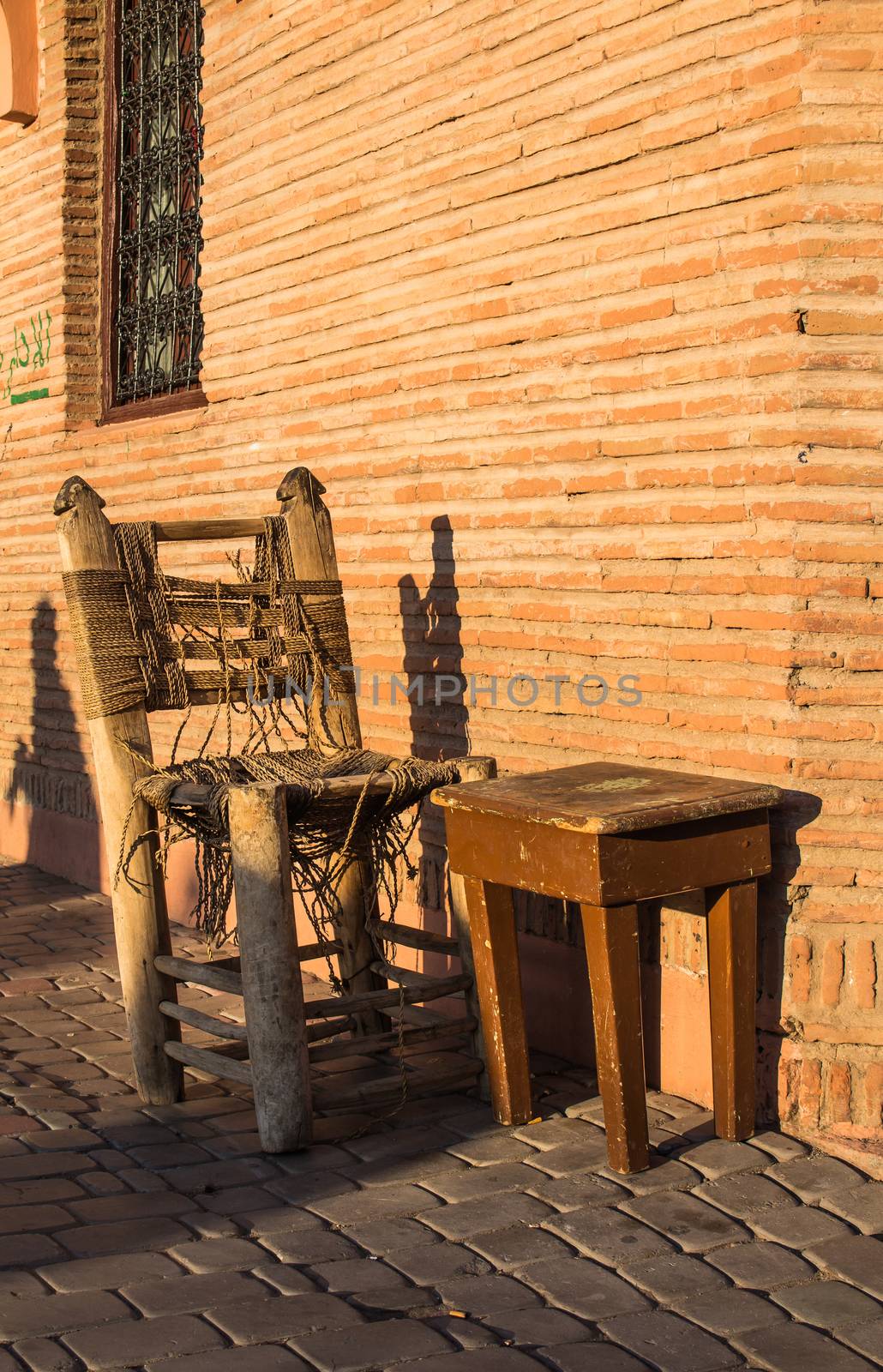 Chair and table of a street cafe, Marrakesh, Morocco by YassminPhoto