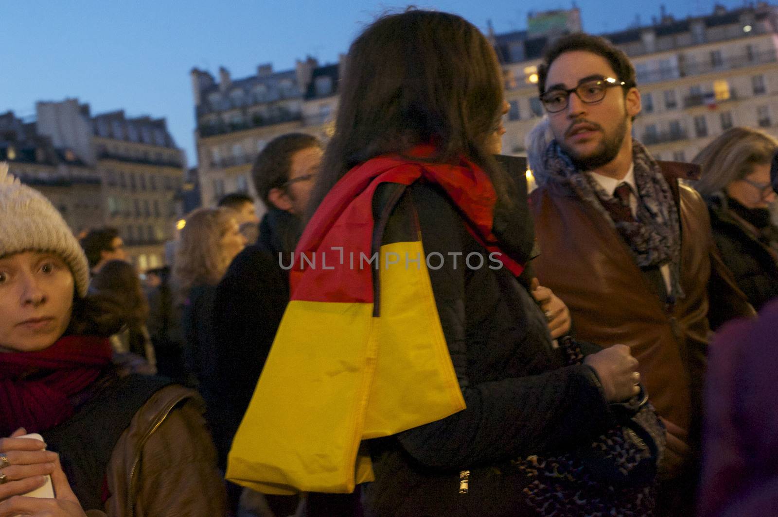 FRANCE, Paris: A woman holds a Belgian flag outside City Hall in Paris, France on March 22, 2016, following the terror attacks in Brussels.Anne Hidalgo, Jean-Marc  Ayrault,  Danièle  Simmonet, Pierre Laurent, Bertrand  Delanoë, Nathalie  Kosciusko-Morizet and other political and religious figures Held a minute of silence in memory of the attack victims. 