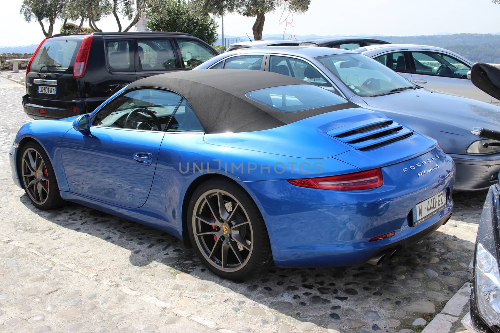 Saint-Paul-de-Vence, France - March 22, 2016: Blue Porsche 911 Carrera S Cabriolet Parked in a Parking Lot in Saint-Paul-de-Vence, Southeastern France