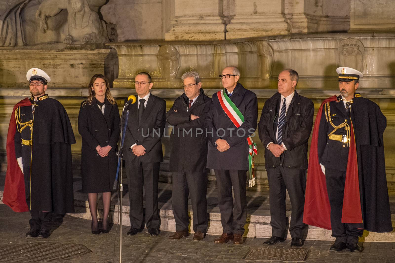 ITALY, Rome: Rome Commissioner Francesco Paolo Tronca (center-right, wrapped in Italian flag) is joined by other officials at Capitoline Hill in Rome, Italy as they pay tribute following the terror attacks that left at least 30 people dead in Brussels, Belgium on March 22, 2016. The Islamic State terror group has taken responsibility for the attacks, which brought death and destruction on Zaventem airport and Maelbeek metro station.