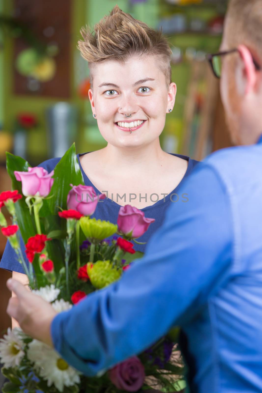 Smiling Woman in Flower Shop Purchases Arrangement by Creatista