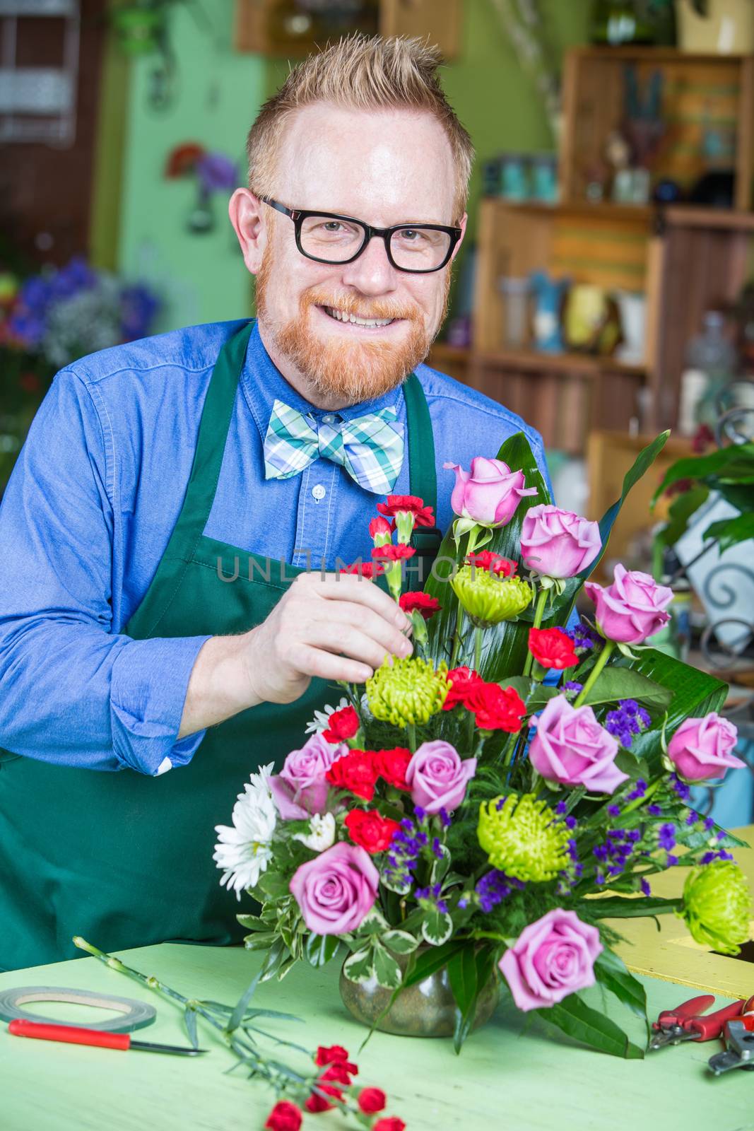 Single handsome man creating a flower arrangement