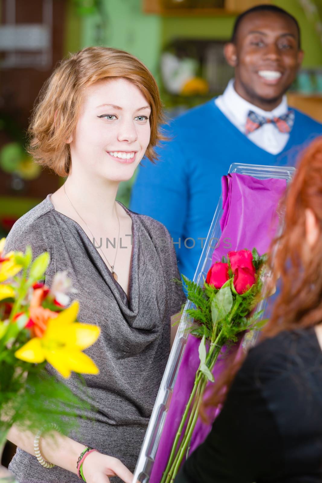 Teen girl purchasing roses at a florist shop