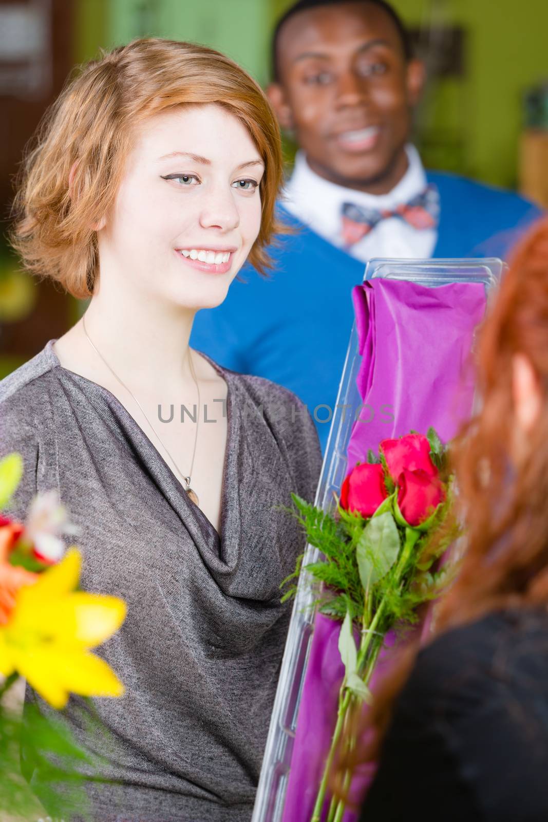 Teenager buying roses at a florist shop