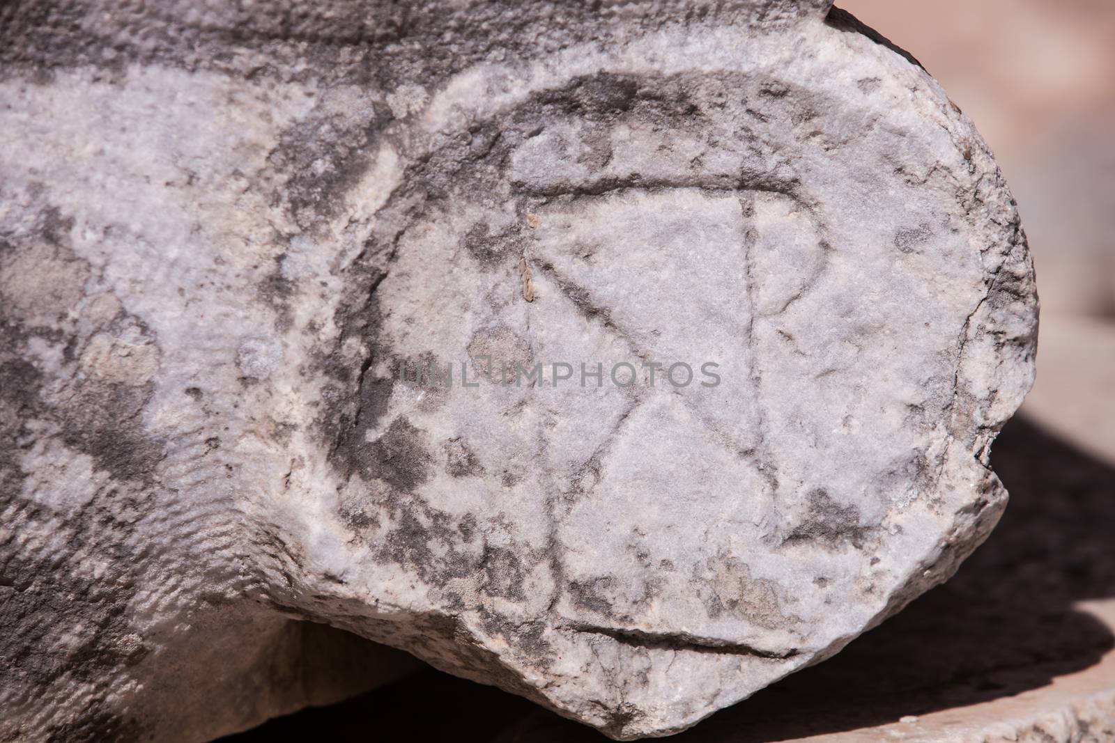 Christian symbol carved into ancient stone at Ephesus in Turkey