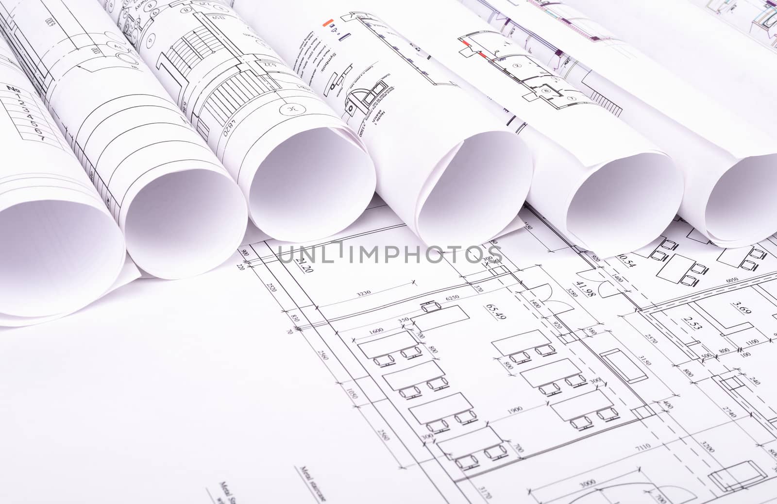 Blueprints and rolls of blueprints, close up view. Building concept