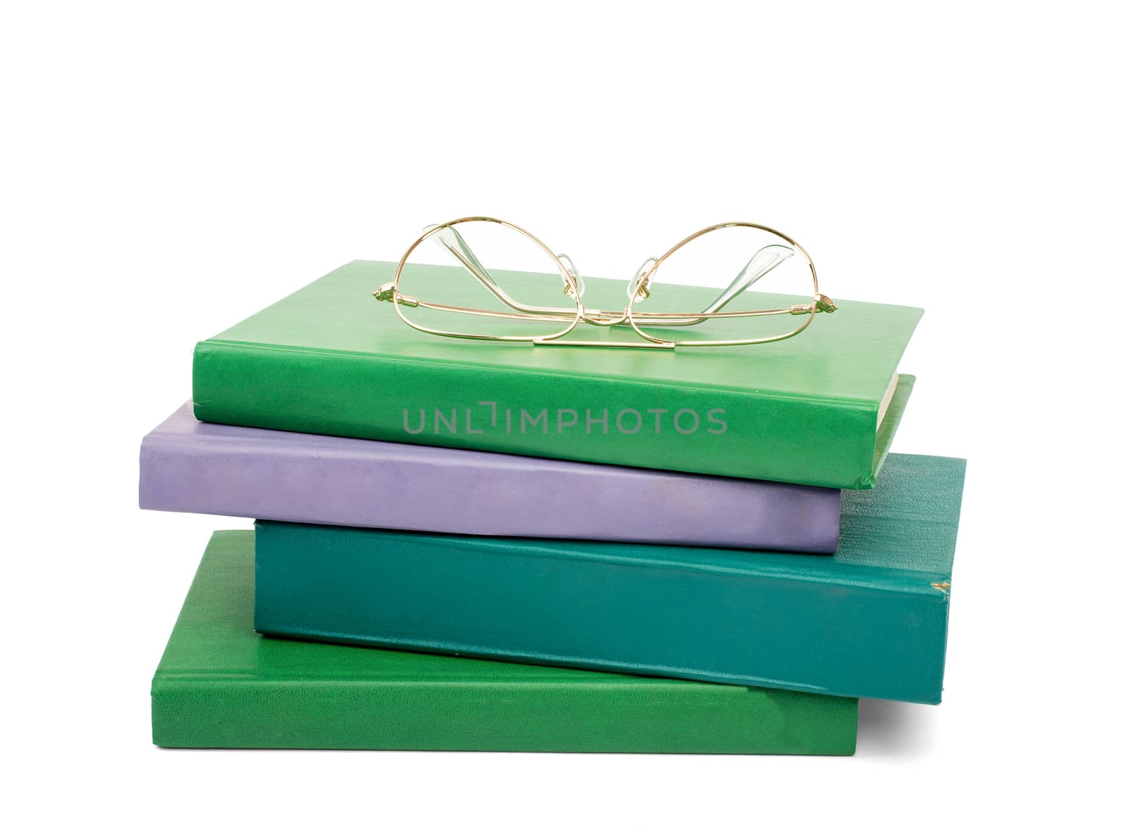 Pile of books with glasses isolated on white background