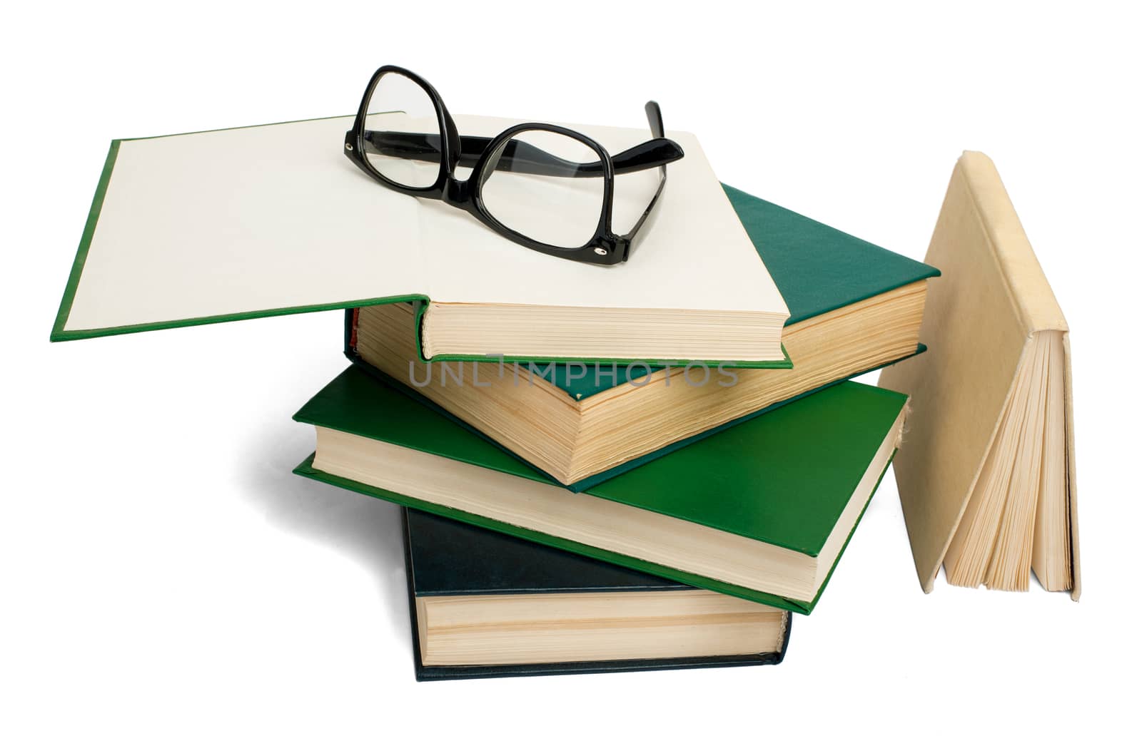 Pile of books with eyeglasses isolated on white background, closeup