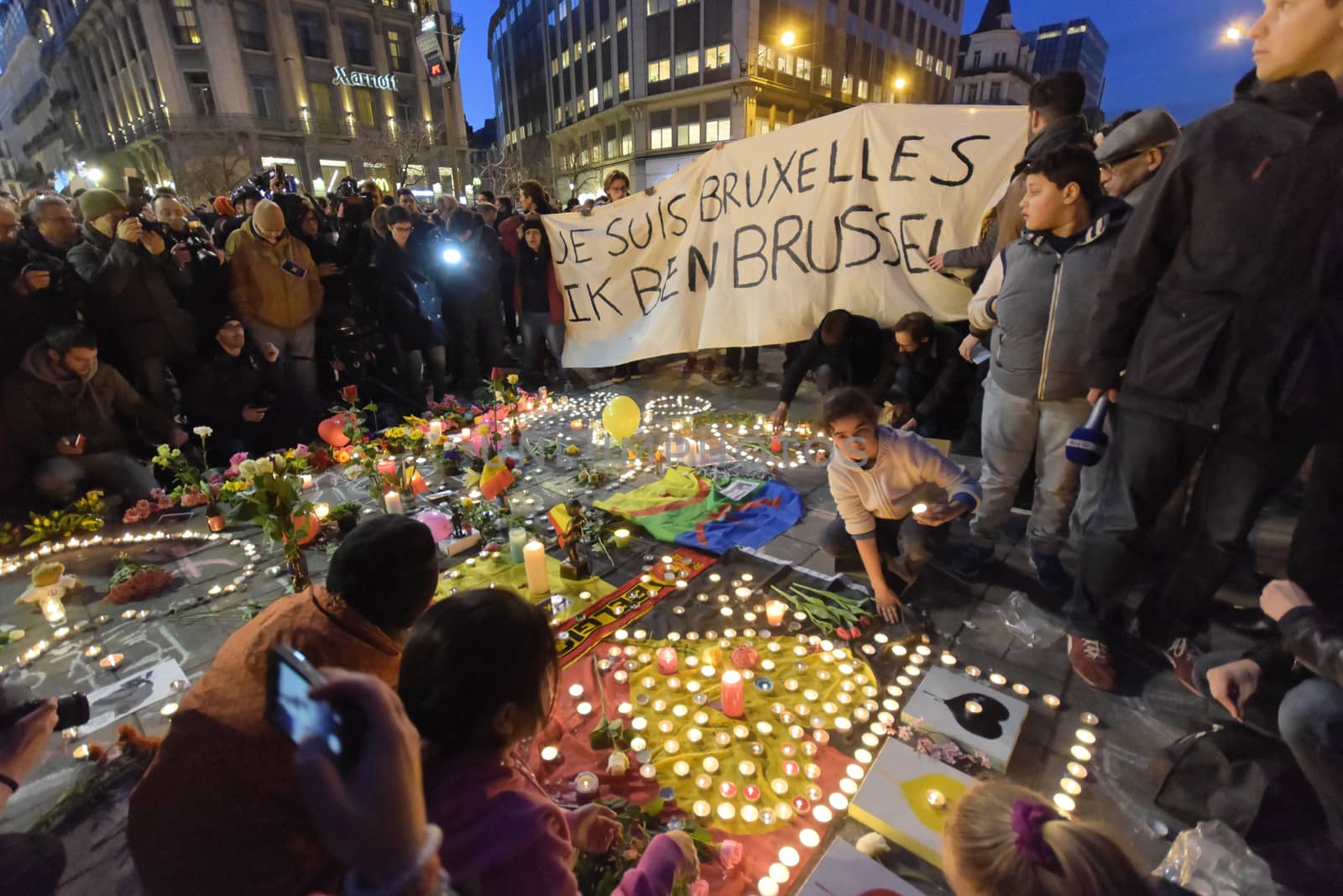 BELGIUM, Brussels: A banner which reads I am Brussels is seen as thousands gather around a makeshift memorial to pay tribute and mourn the victims of the bomb attacks, at the Place de la Bourse, in Brussels, Belgium, March 22, 2016.