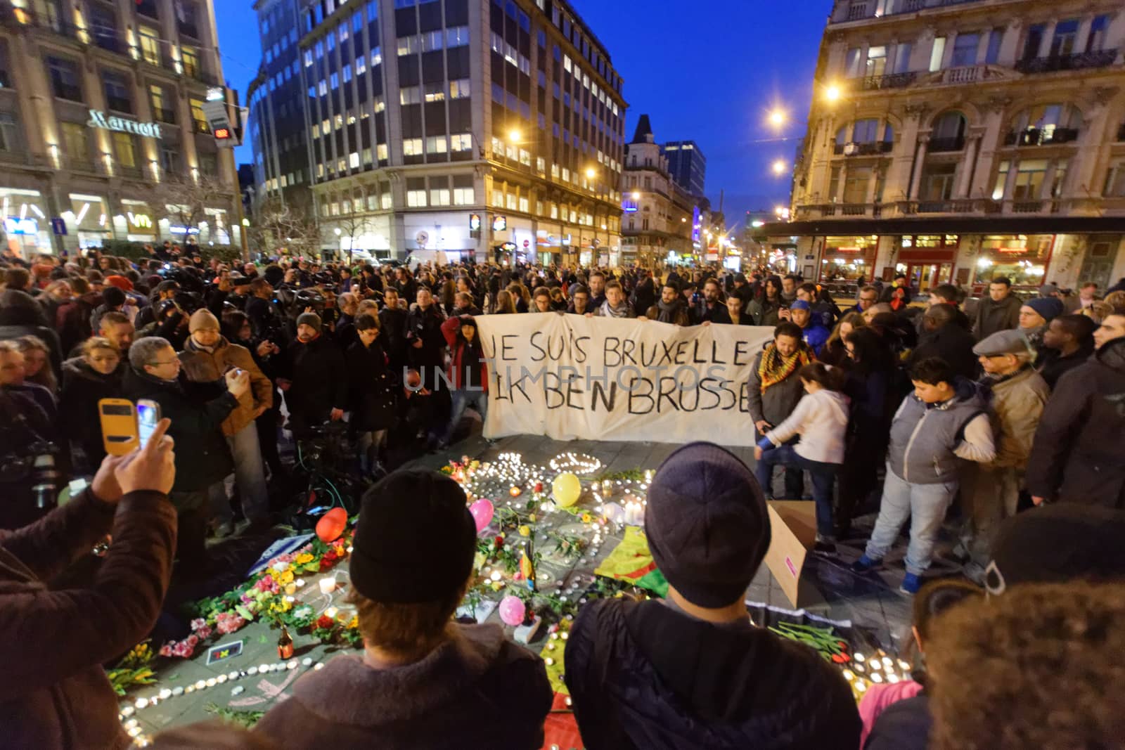 BELGIUM, Brussels: A banner which reads I am Brussels is seen as thousands gather around a makeshift memorial to pay tribute and mourn the victims of the bomb attacks, at the Place de la Bourse, in Brussels, Belgium, March 22, 2016.