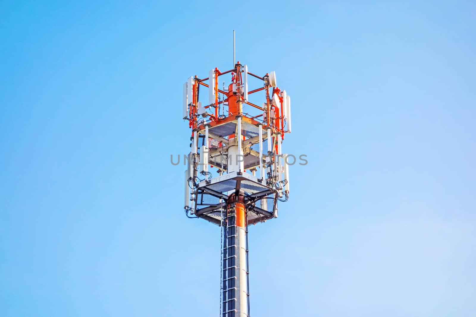 Cell tower and radio antenna, blue sky background