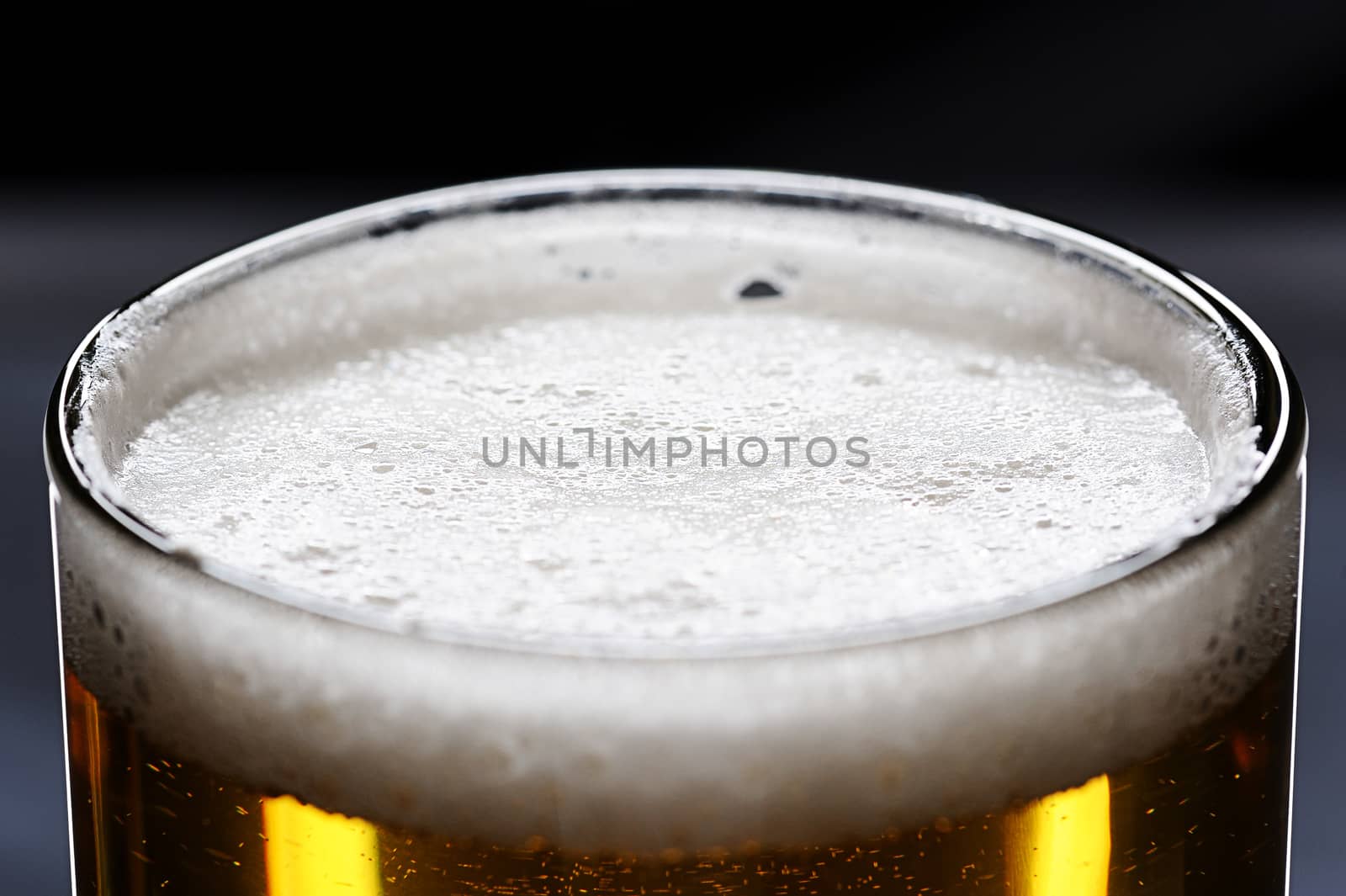 top of glass full with beer and small bubbles