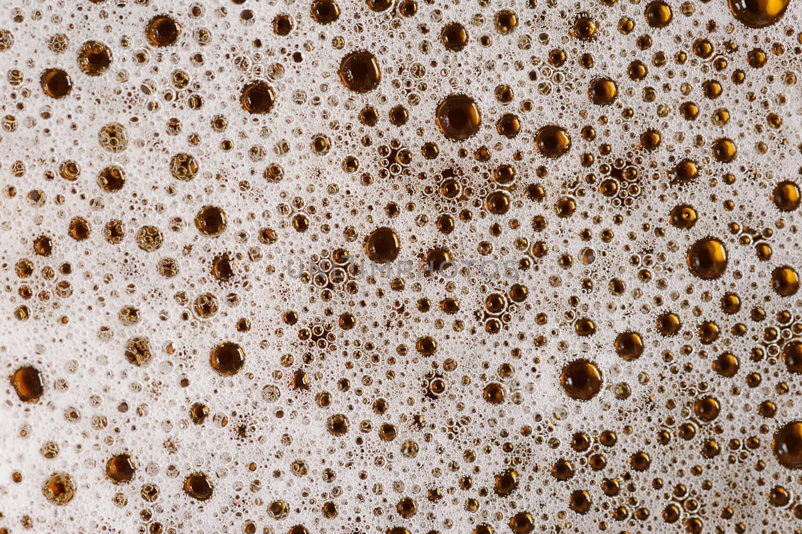 macro of bubbles in brown beer foam