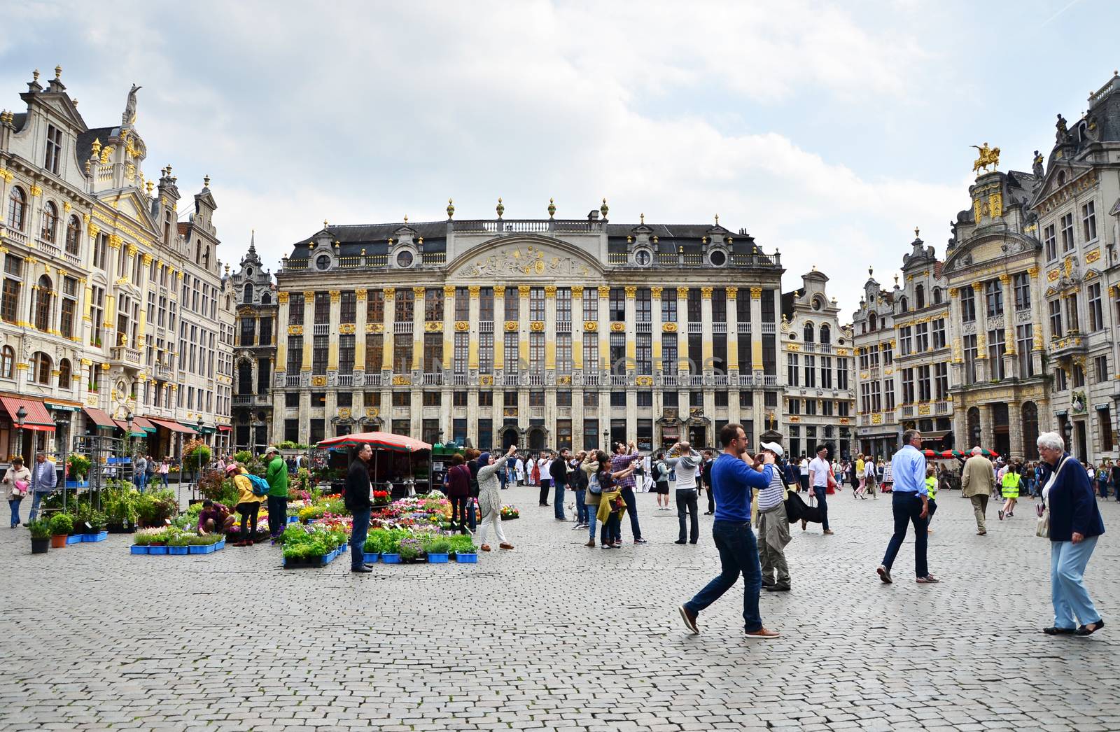 Brussels, Belgium - May 13, 2015: Many tourists visiting famous Grand Place (Grote Markt) the central square of Brussels. by siraanamwong