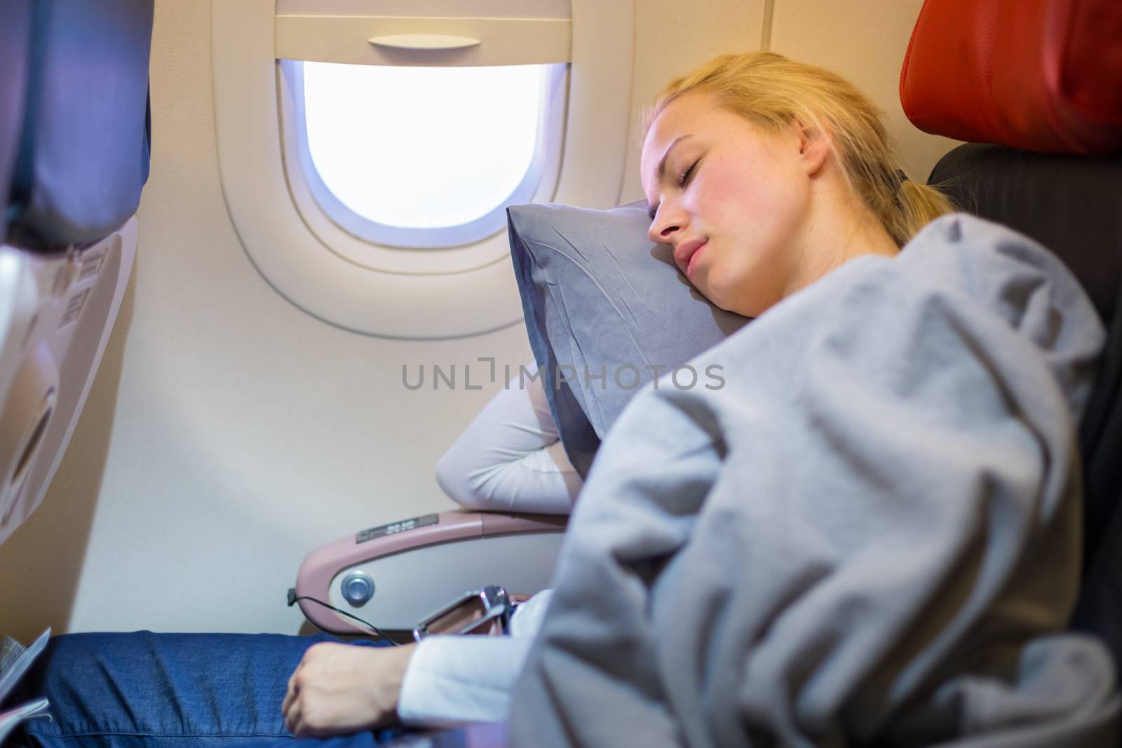 Lady traveling napping on a plain. by kasto