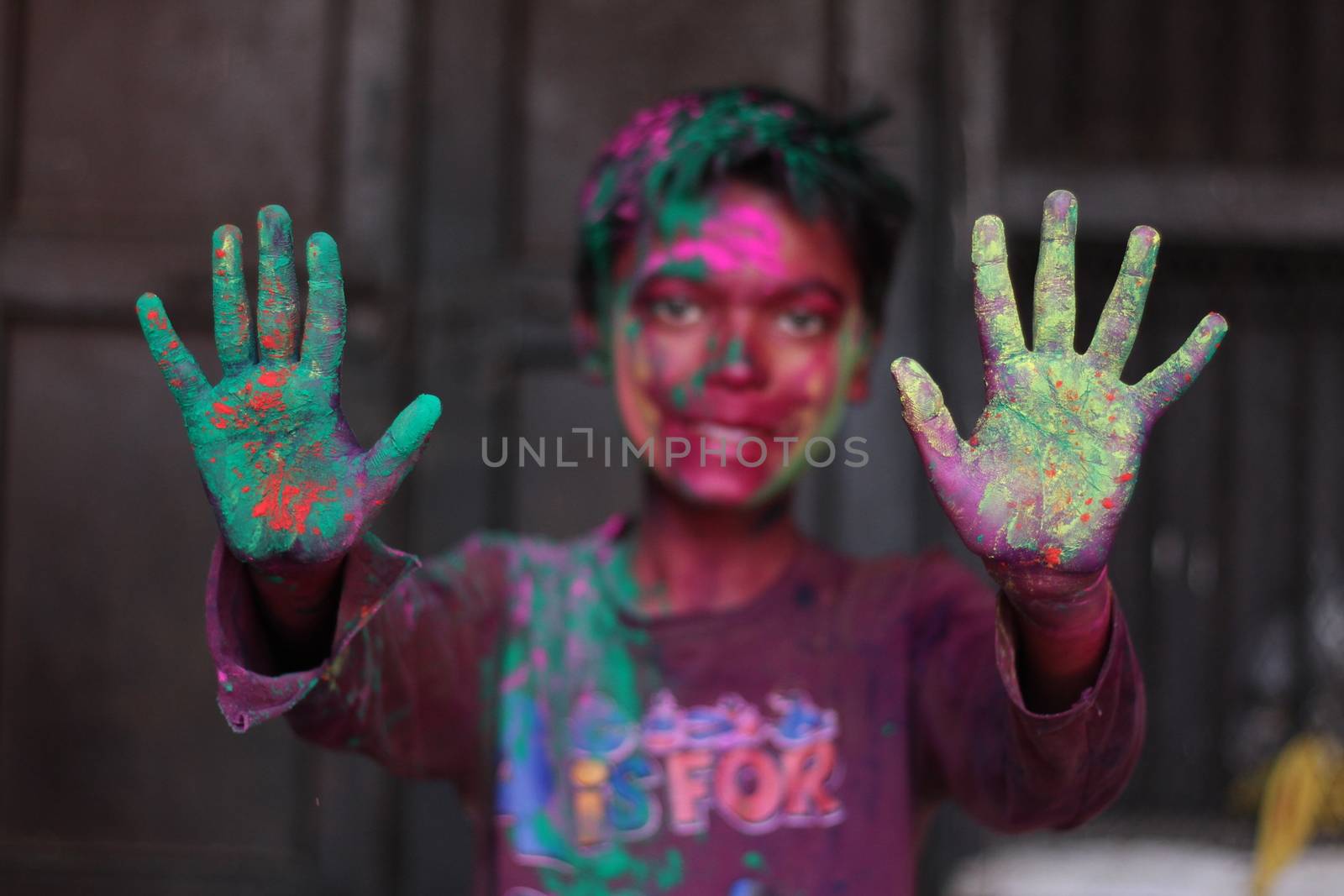 INDIA, Allahabad : An Indian boy celebrates the Holi festival in Allahabad on March 23, 2015. Holi, the Hindu spring festival or 'Festival of Colours' is celebrated with coloured powder and water and marks the end of winter and the beginning of spring. 