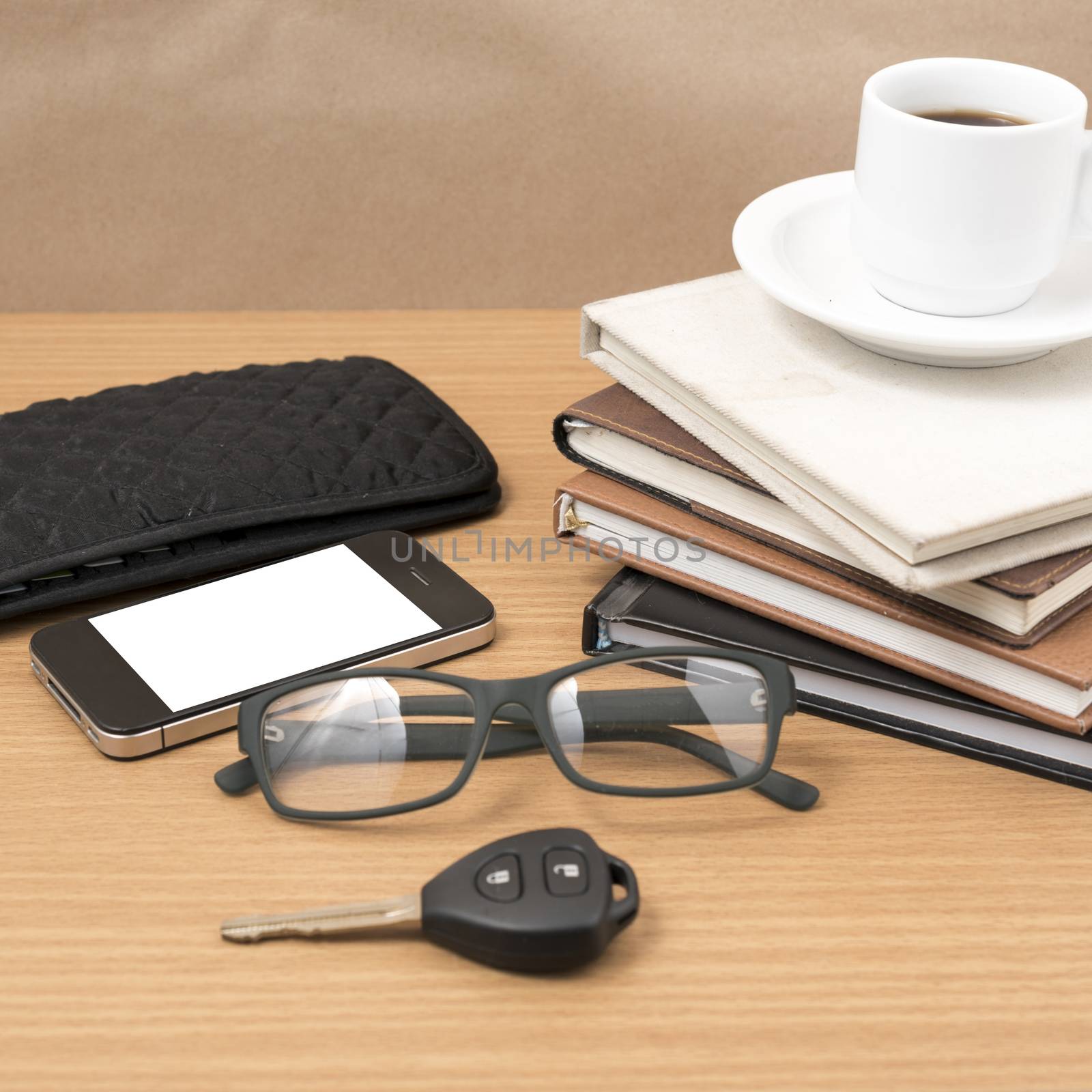 coffee and phone with stack of book,car key,eyeglasses and wallet on wood background