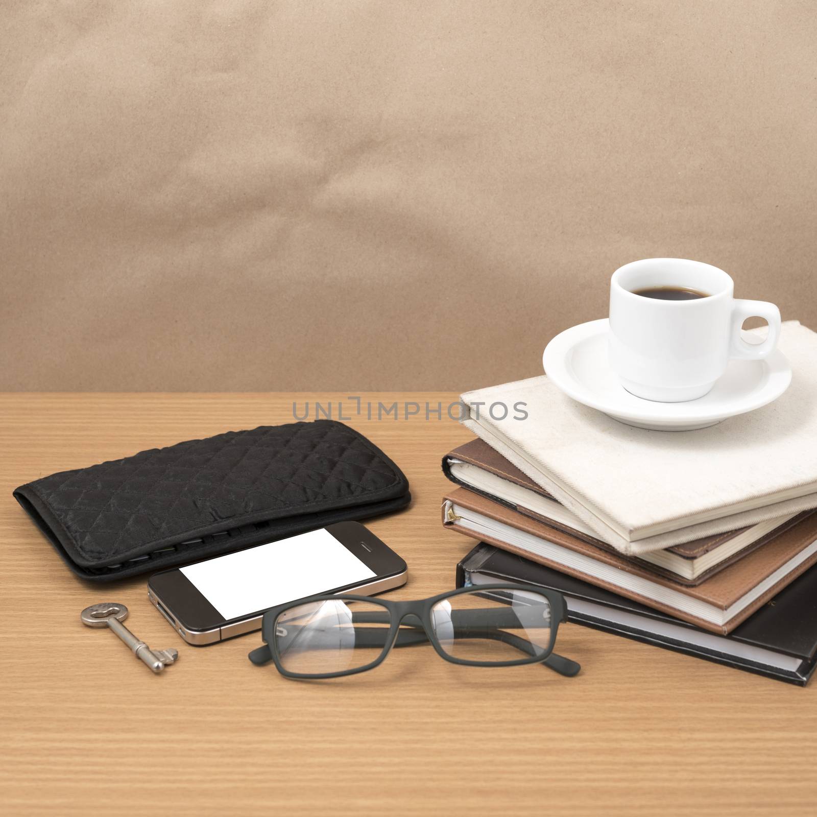 coffee and phone with stack of book,key,eyeglasses and wallet by ammza12