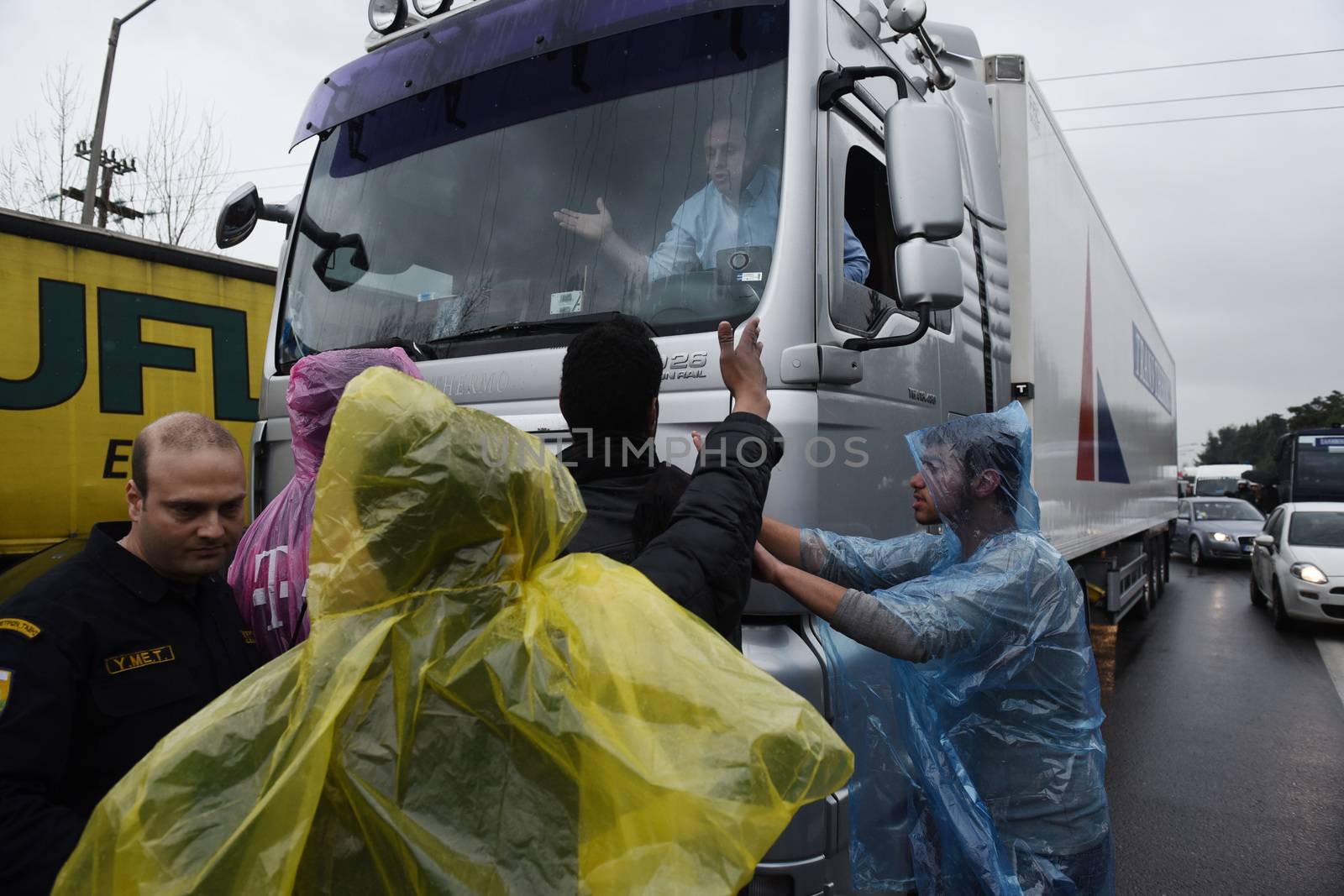 GREECE, Idomeni: A truck driver argues with migrants on the road near the main highway near the northern Greek village of Idomeni at the Greek-Macedonian border on March 23, 2016.People demonstrated demanding for the border to open, in order to continue their trip to northern Europe.