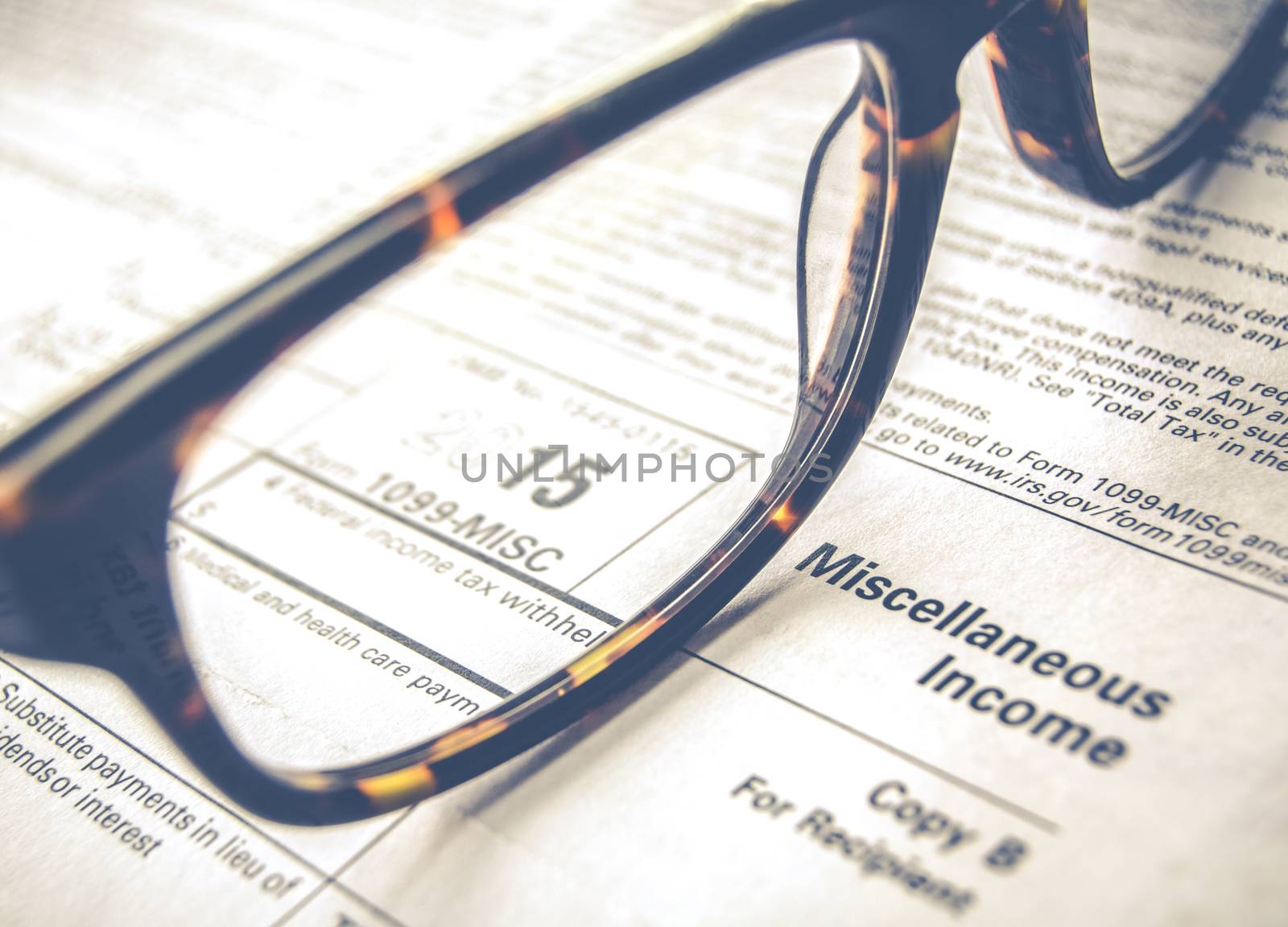 Retro Sepia Detail Of A Tax Form For 2015 Earnings For 2016 Tax Day With Glasses