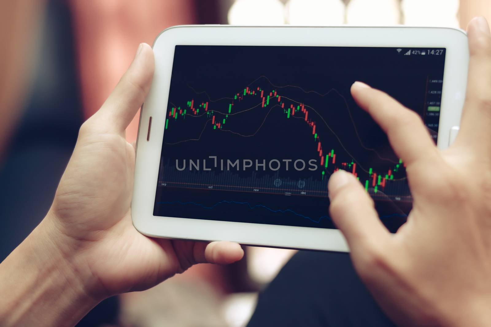 a man checking stock market on tablet, smartphone