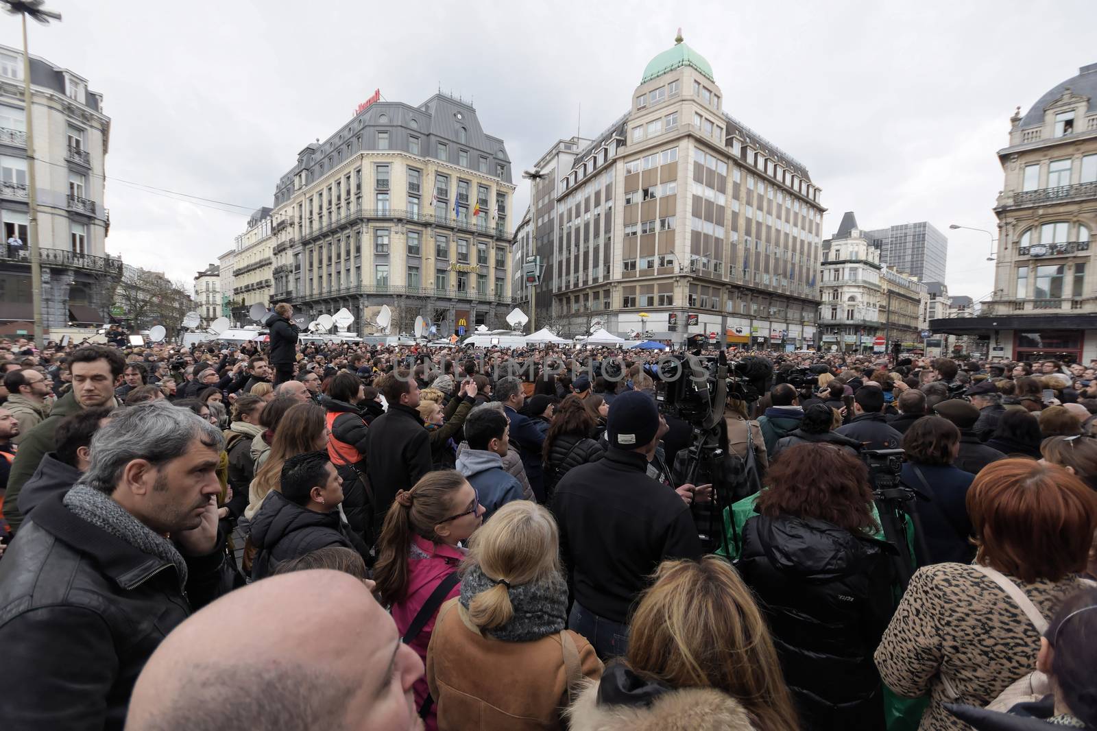 BELGIUM, Brussels: People gather to observe a minute of silence in memory of the victims of the Brussels airport and metro bombings, on the Place de la Bourse in central Brussels, on March 23, 2016, a day after the triple blasts killed at least 31 people and left around 250 injured. World leaders united in condemning the carnage in Brussels and vowed to combat terrorism, after Islamic State bombers killed around 35 people in a strike at the symbolic heart of the EU.