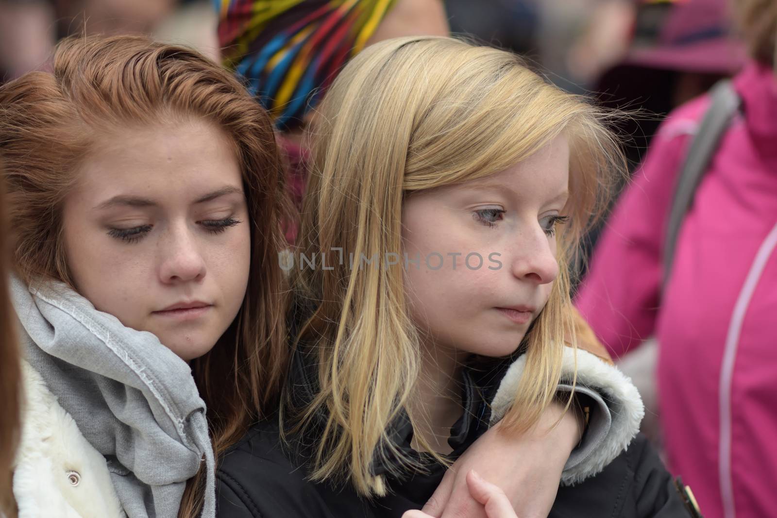 BELGIUM, Brussels: Two girls cry as people gather to observe a minute of silence in memory of the victims of the Brussels airport and metro bombings, on the Place de la Bourse in central Brussels, on March 23, 2016, a day after the triple blasts killed at least 31 people and left around 250 injured. World leaders united in condemning the carnage in Brussels and vowed to combat terrorism, after Islamic State bombers killed around 35 people in a strike at the symbolic heart of the EU.