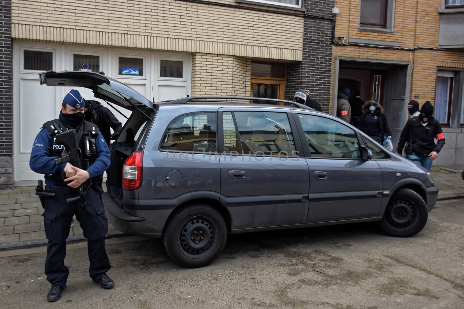 BRUSSELS, Anderlecht: Members of Belgian police make searches at a flat in Anderlecht on March 23, 2016, Belgium. Earlier an arrest was made in connection with the Brussels terrorist attacks. Belgium is observing three days of national mourning after 34 people were killed in a twin suicide blast at Zaventem Airport and a further bomb attack at Maelbeek Metro Station. Two brothers are thought to have carried out the airport attack and an international manhunt is underway for a third suspect. The attacks come just days after a key suspect in the Paris attacks, Salah Abdeslam, was captured in Brussels.