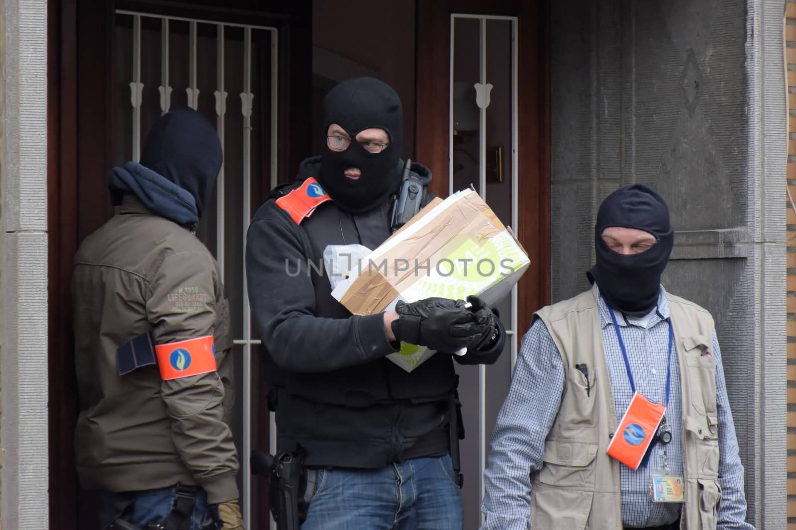 BRUSSELS, Anderlecht: Members of Belgian police make searches at a flat in Anderlecht on March 23, 2016, Belgium. Earlier an arrest was made in connection with the Brussels terrorist attacks. Belgium is observing three days of national mourning after 34 people were killed in a twin suicide blast at Zaventem Airport and a further bomb attack at Maelbeek Metro Station. Two brothers are thought to have carried out the airport attack and an international manhunt is underway for a third suspect. The attacks come just days after a key suspect in the Paris attacks, Salah Abdeslam, was captured in Brussels.