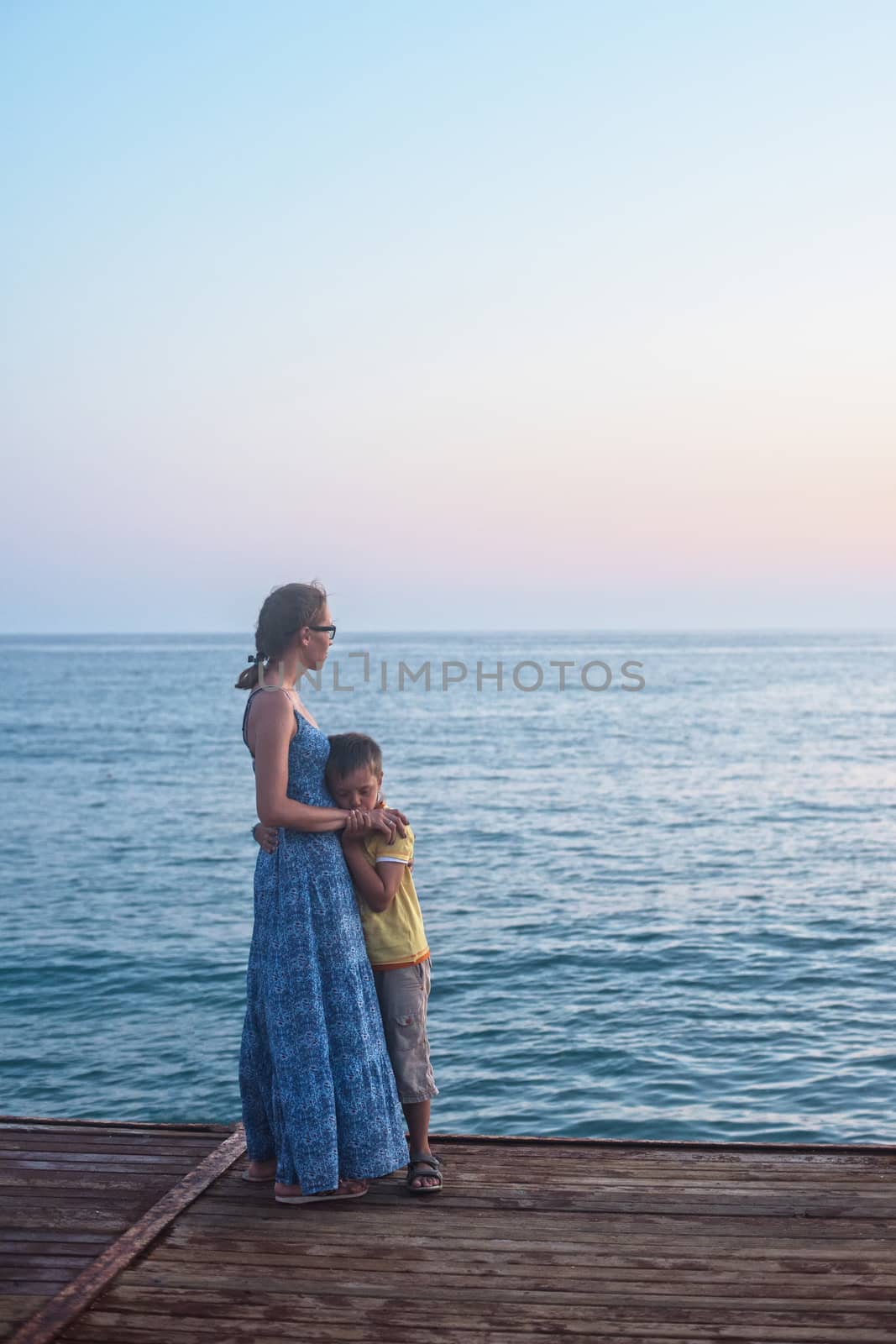 mother and son on the pier in the evening at Alania, Turkey