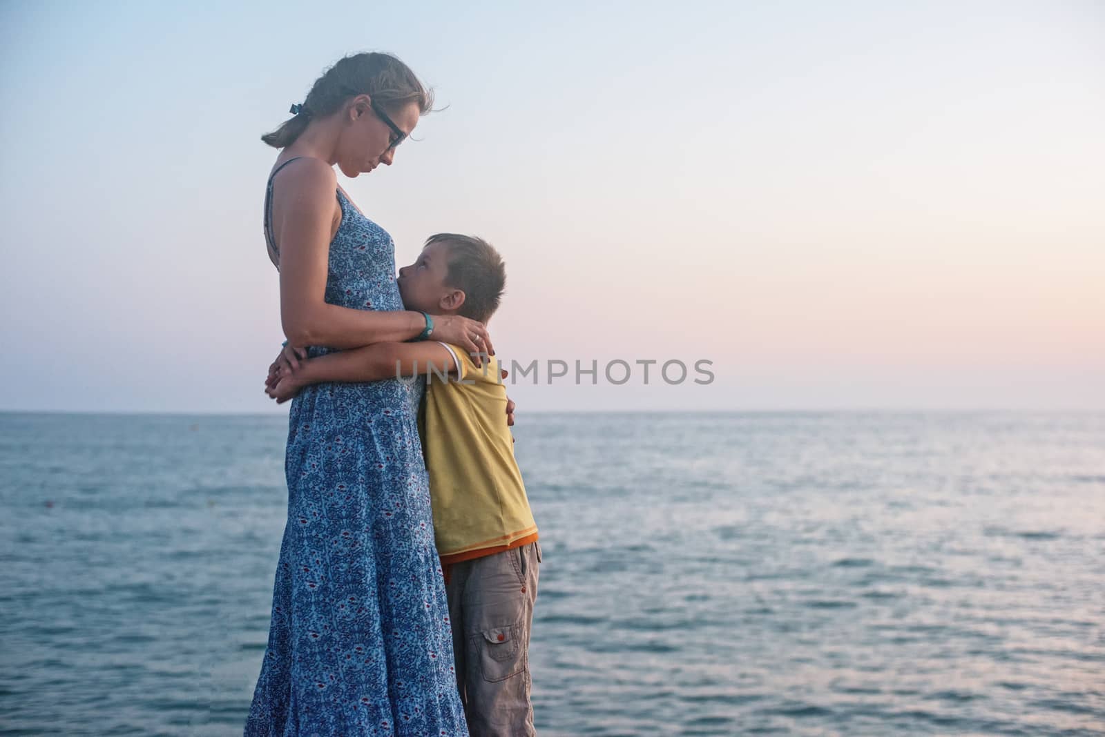 mother and son on the pier in the evening at Alania, Turkey