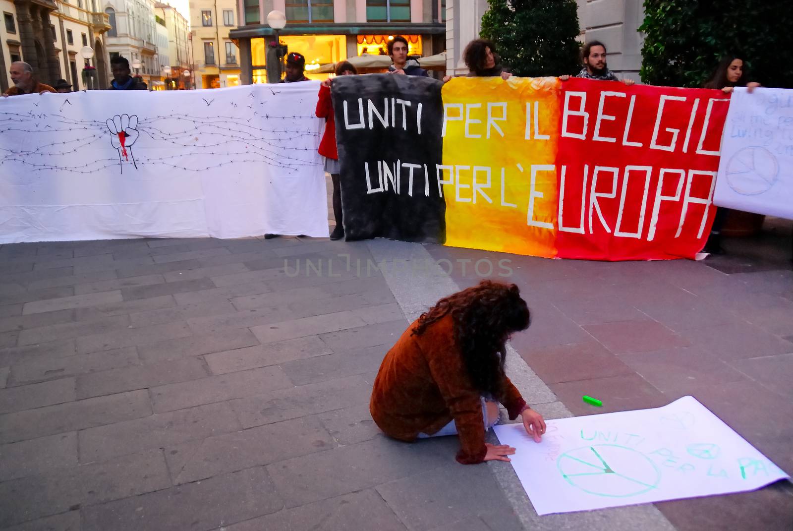 ITALY, Padova: A flash mob holds a series of illustrated signs in Padova, Italy on March 23, 2016 as a show of solidarity with the victims of the terror attacks in Brussels, Belgium the day previous. On March 22, a series of bombings killed at least 30 people and injured hundreds of others, both at Zaventem airport and at Maelbeek metro station. The Islamic State terror group has since claimed responsibility for the attack.