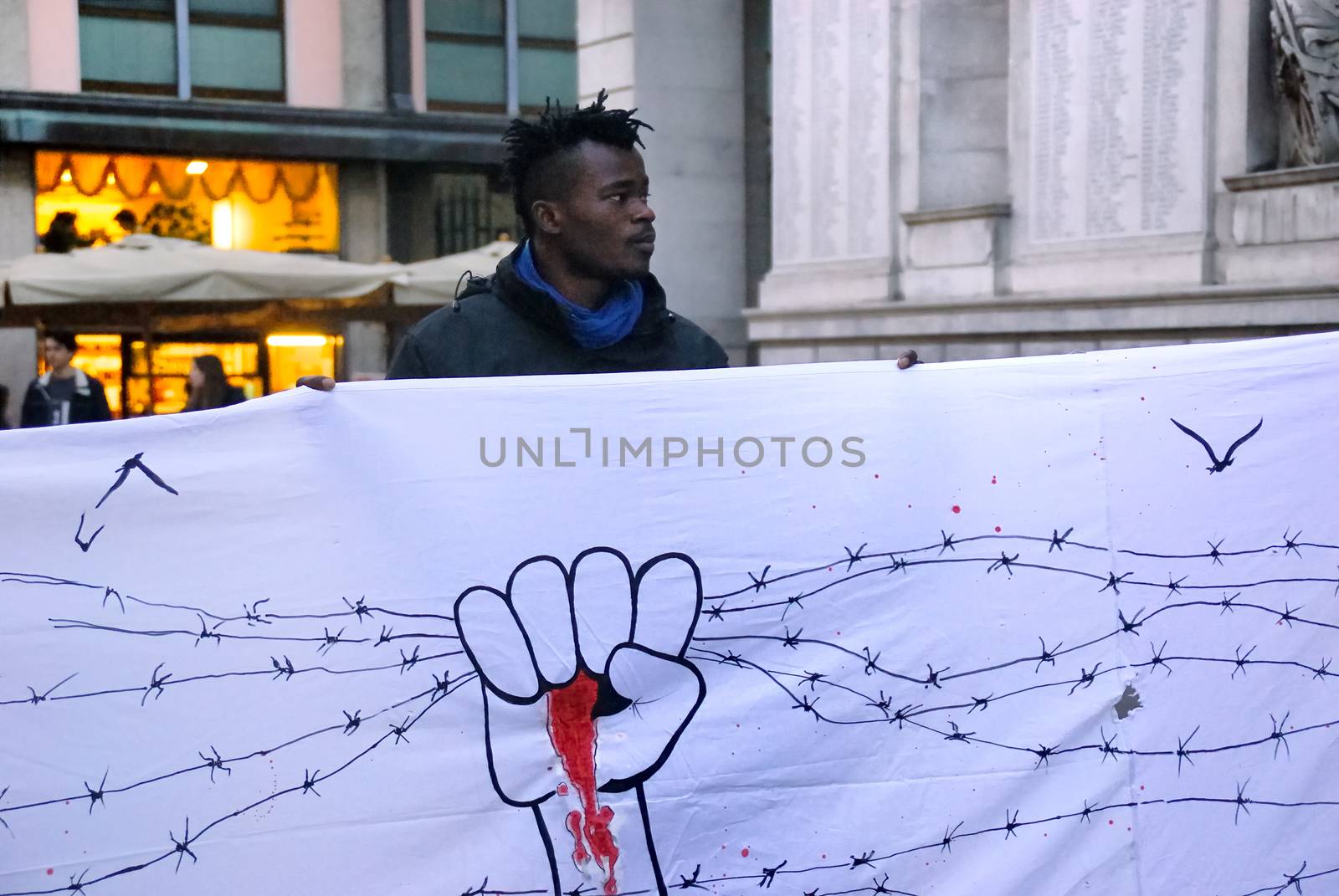 ITALY, Padova: A member of a flash mob in Padova, Italy holds an illustrated sign on March 23, 2016 as a show of solidarity with the victims of the terror attacks in Brussels, Belgium the day previous. On March 22, a series of bombings killed at least 30 people and injured hundreds of others, both at Zaventem airport and at Maelbeek metro station. The Islamic State terror group has since claimed responsibility for the attack.