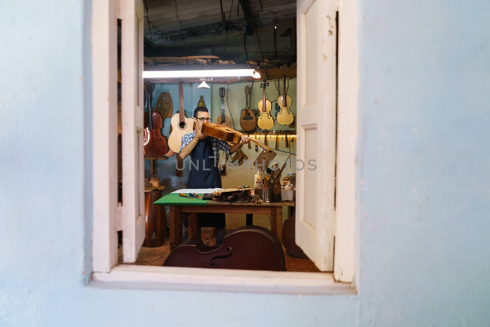 Lute Maker Checking Classic Guitar In Atelier Of Music Instrumen by diego_cervo