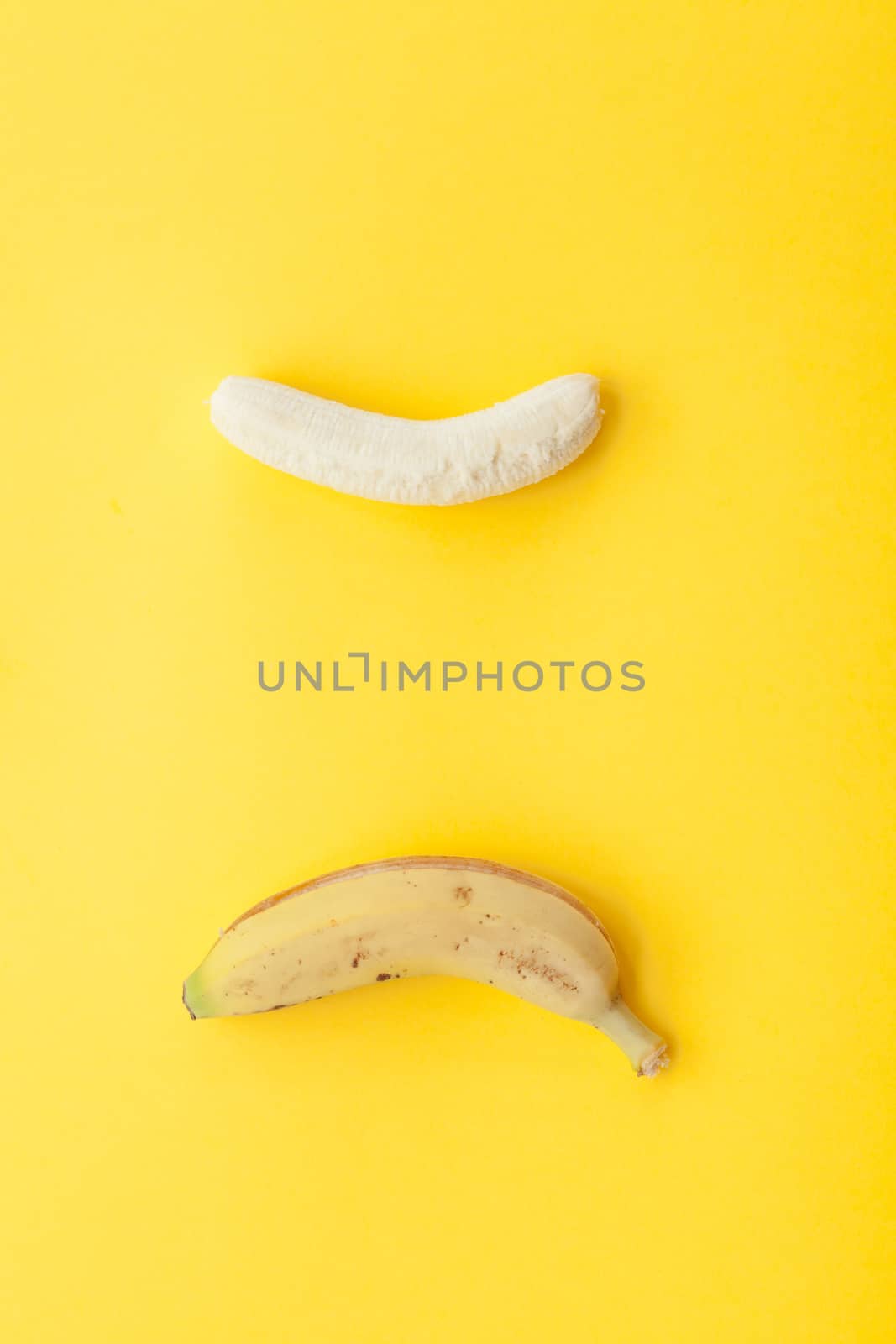 Peel banana and fruit on a yellow background by andongob